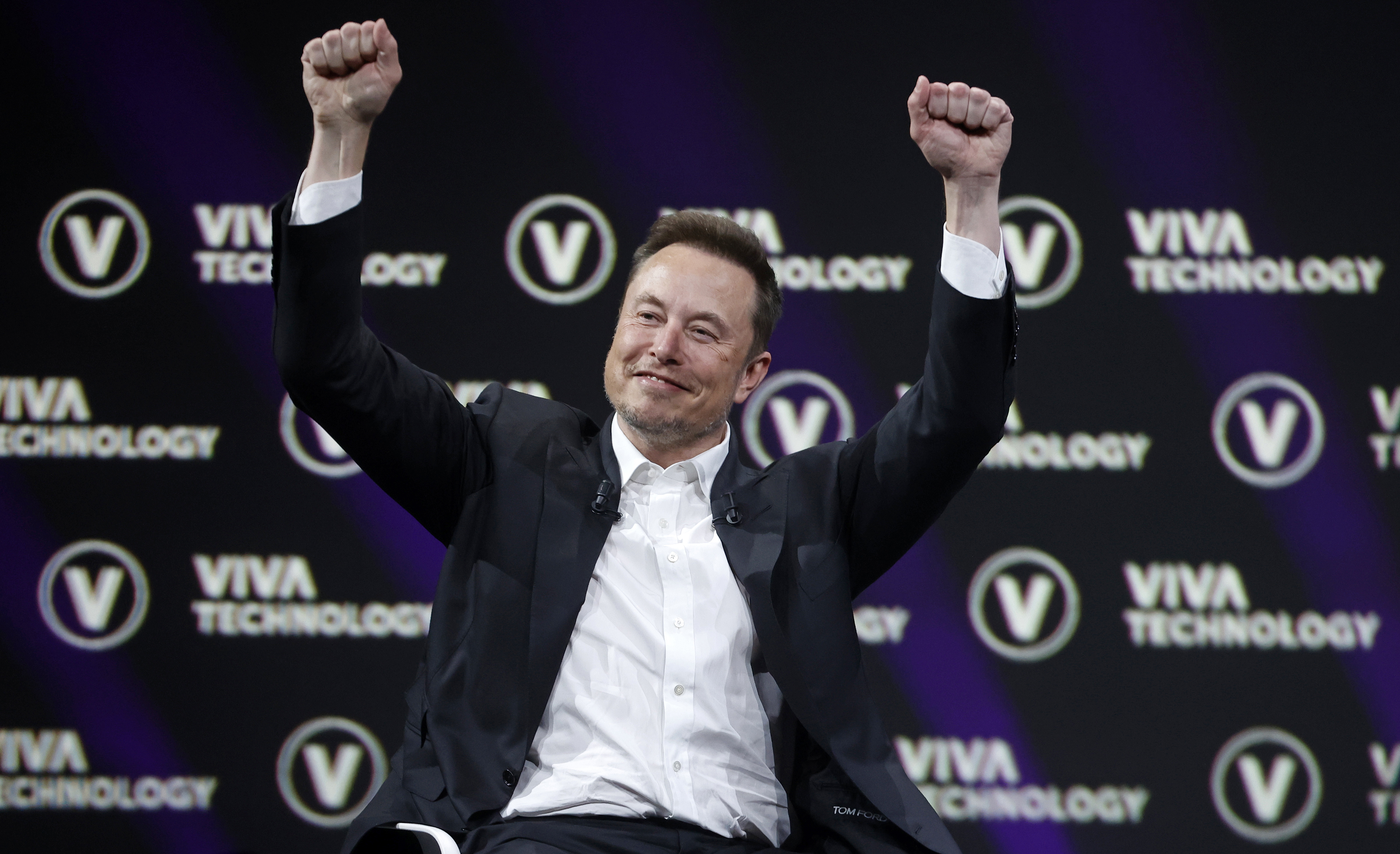 Elon Musk raising his arms