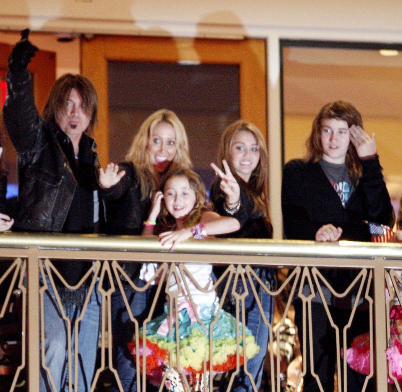 The former couple and their kids on a balcony