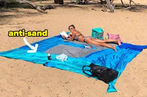 person spread out on huge blanket at the beach