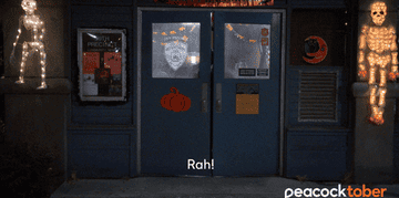 gif of character from brooklyn 99 running in fear in room with halloween decor