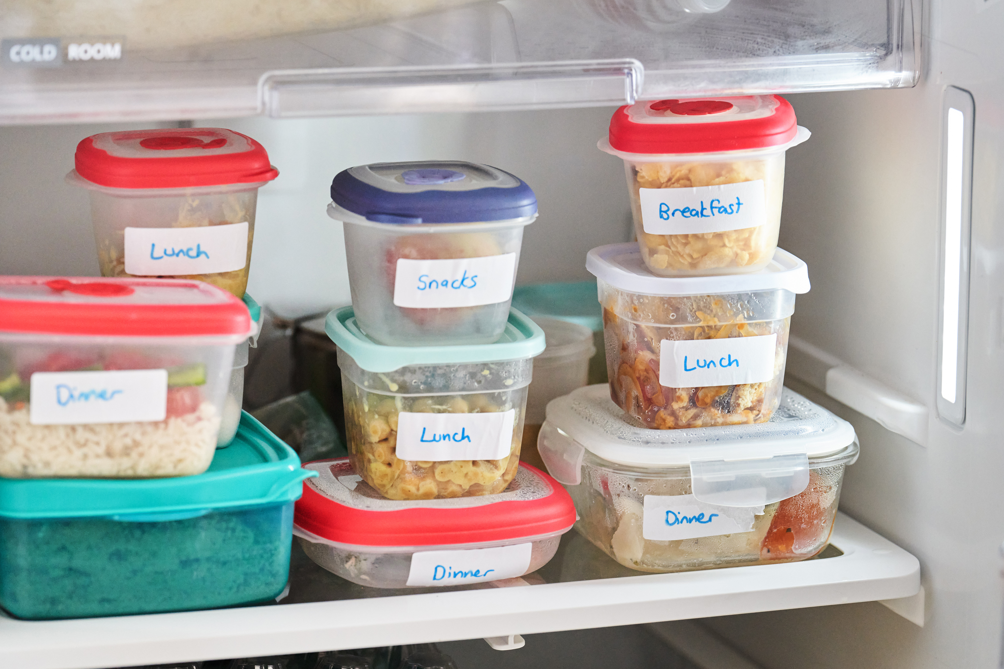 several containers of leftovers in a fridge