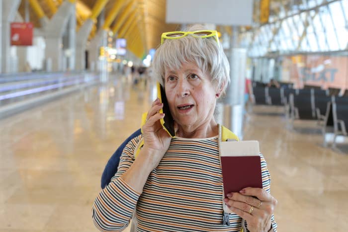 A woman speaking on the phone in an airport