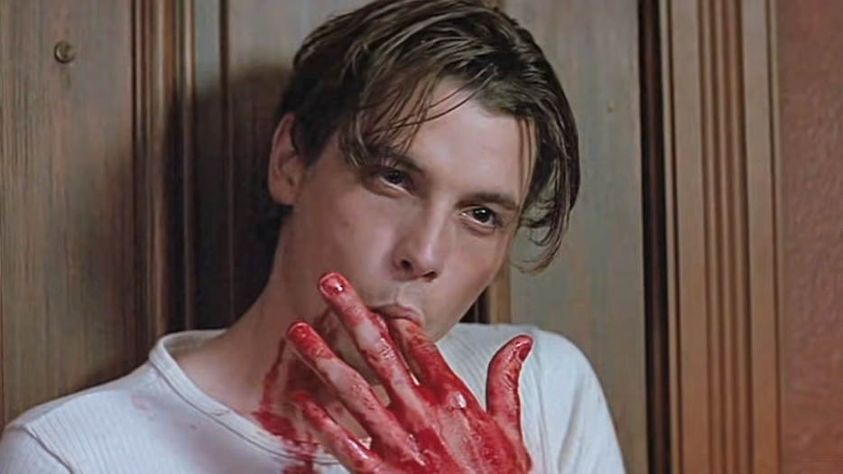 Close-up of Skeet licking a bloody finger