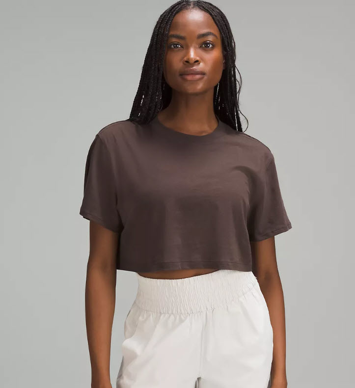 model in cropped brown t-shirt