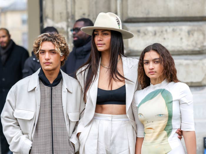 Camila standing for photos with two of her children outside of an event