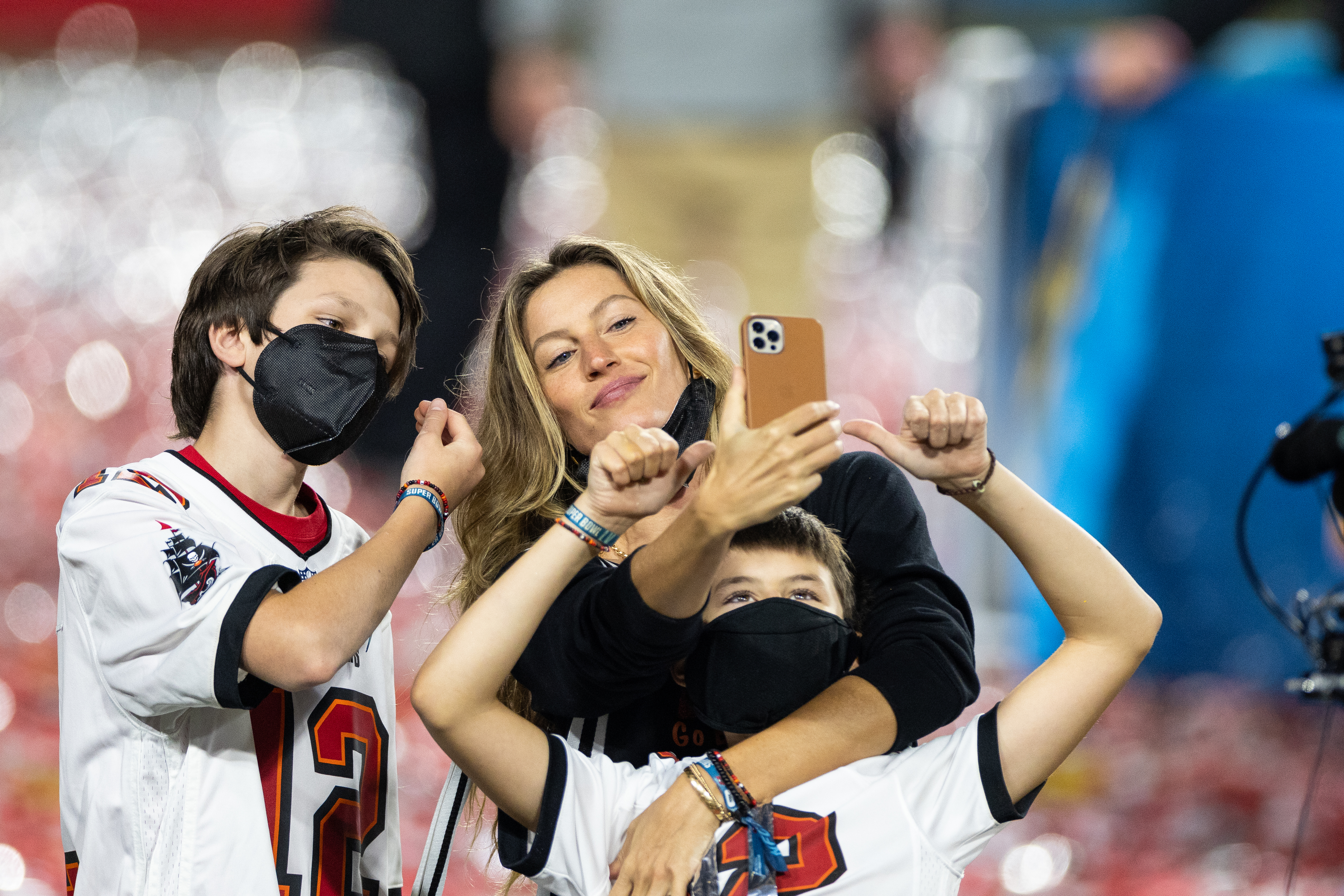 Gisele taking a selfie with Jack on the football field