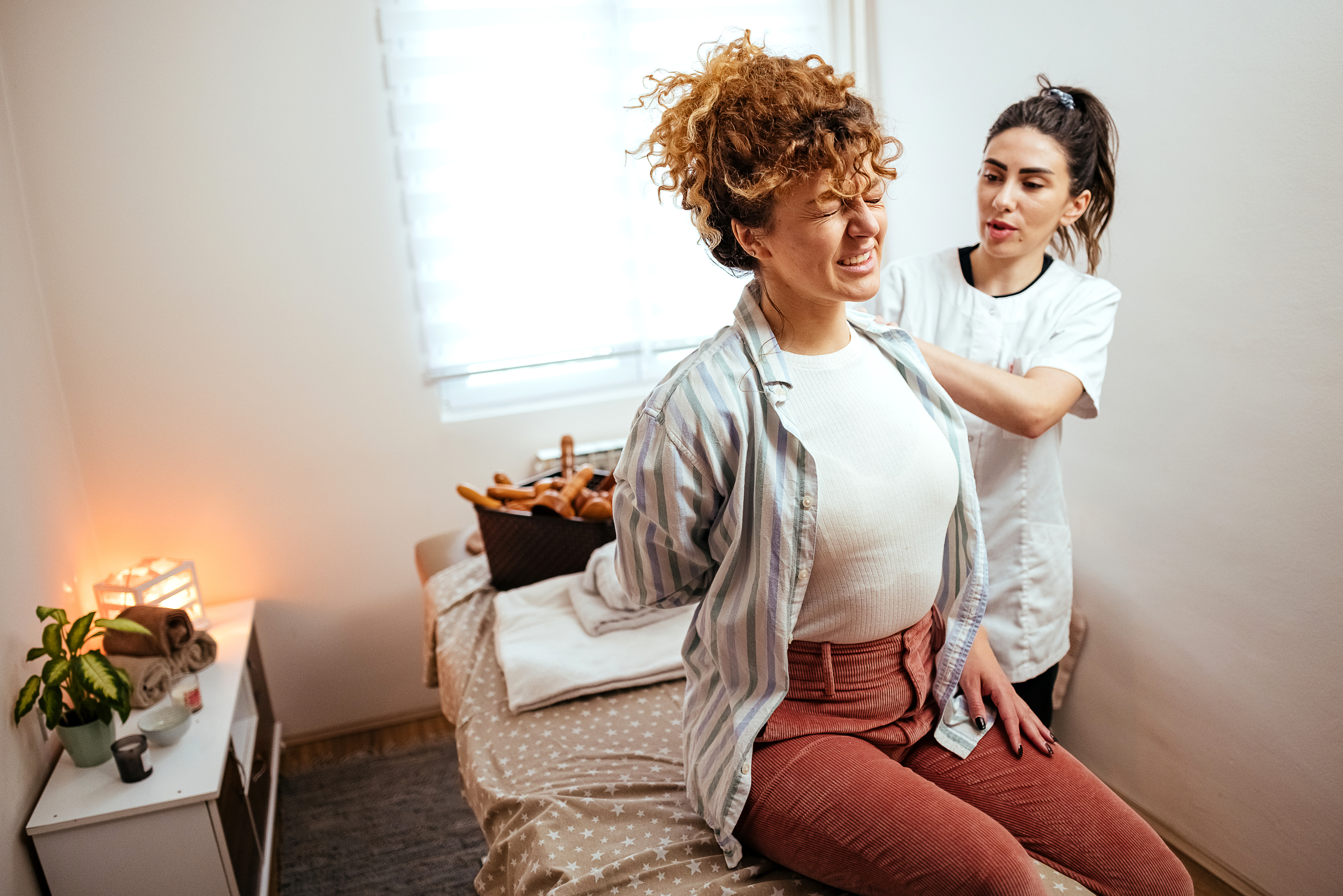 A woman being seen by a physical therapist