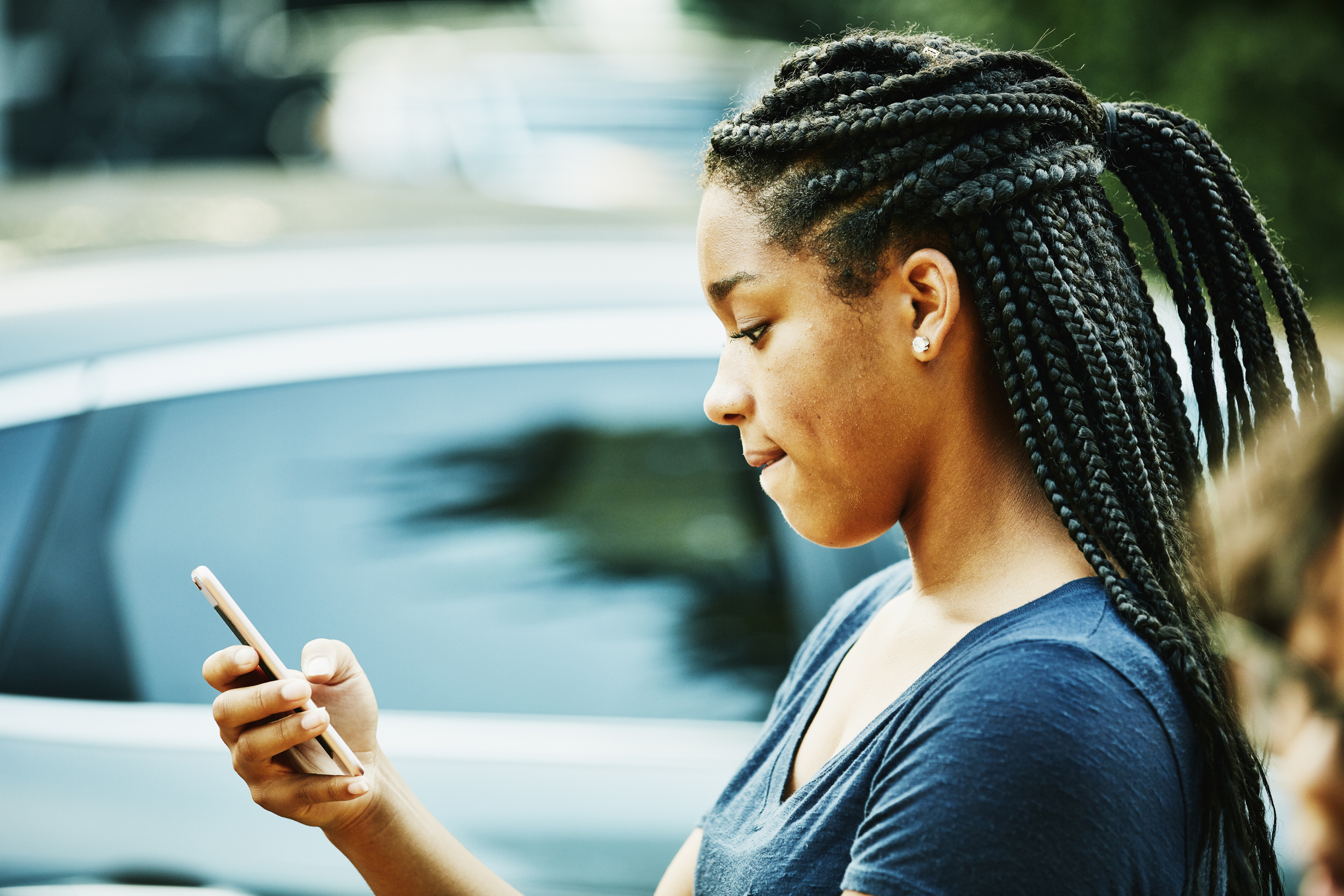 A young girl looking at her phone