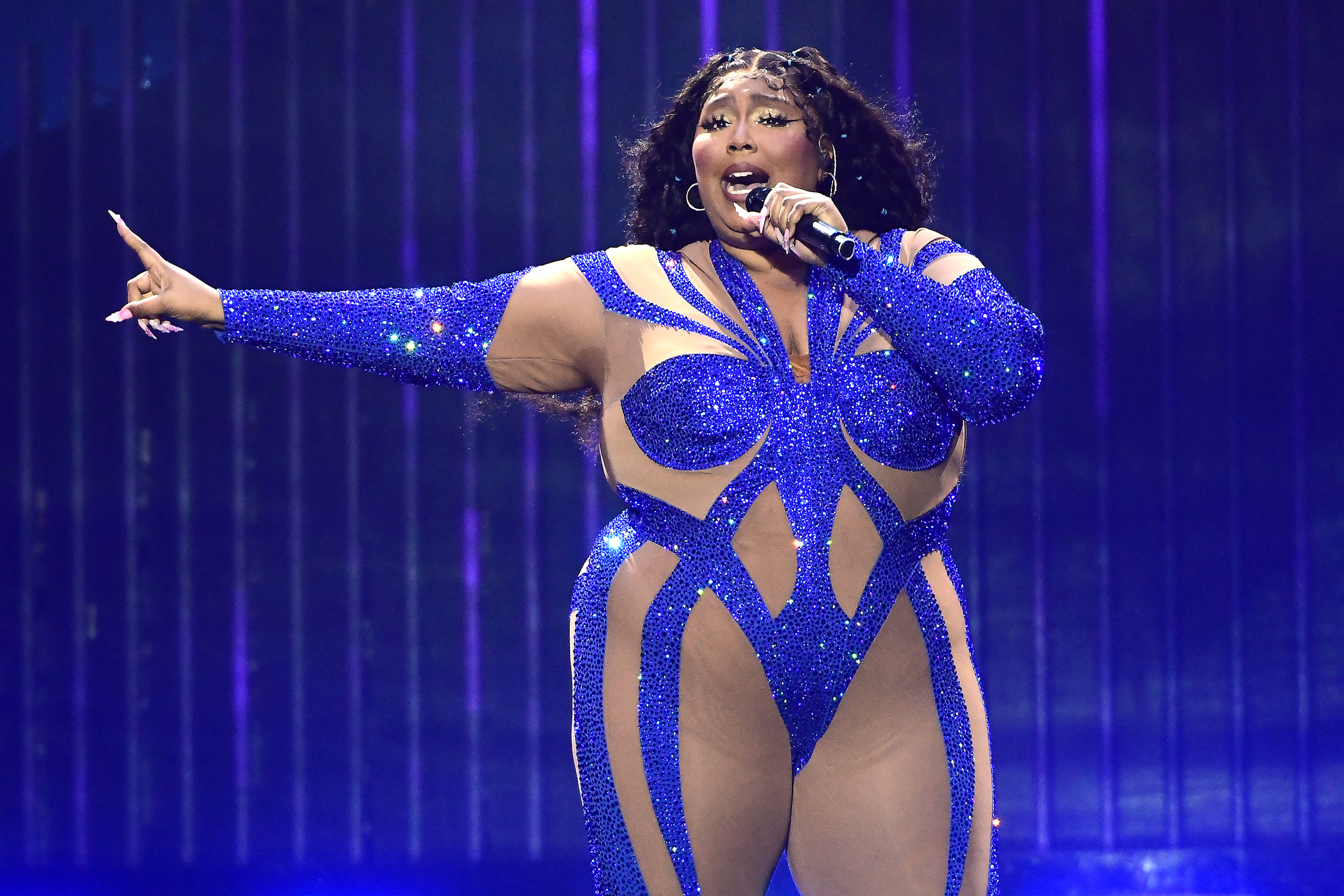 Lizzo onstage in a leotard