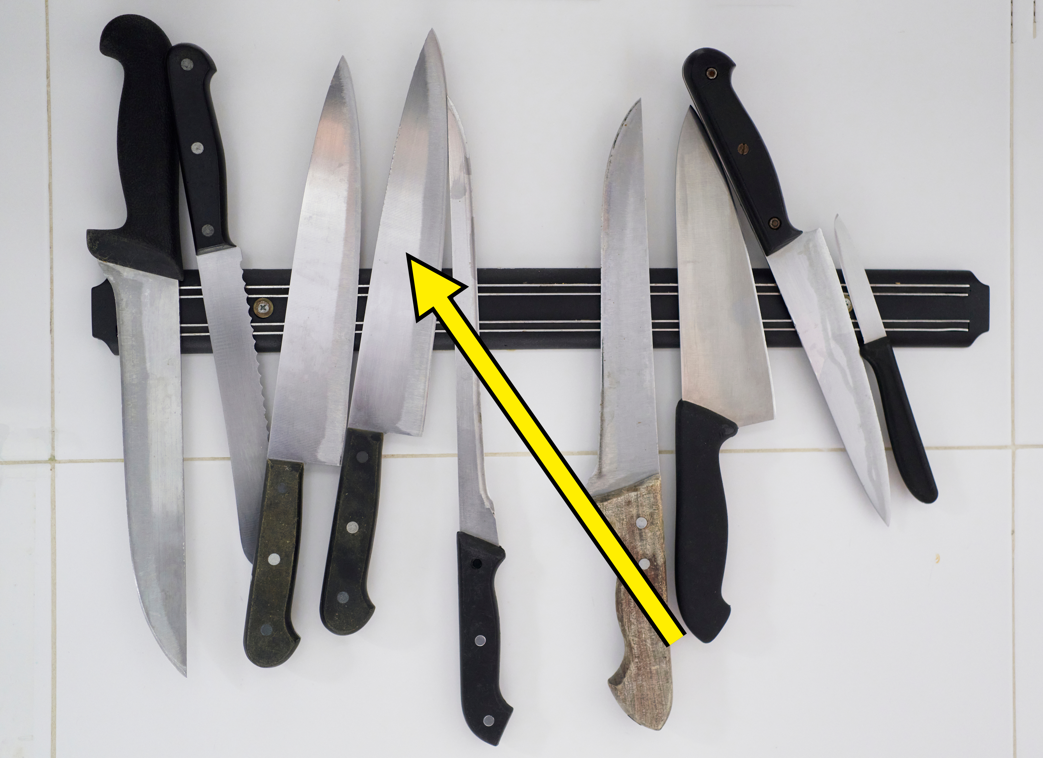 knives on a knife magnetic strip hanging on the wall