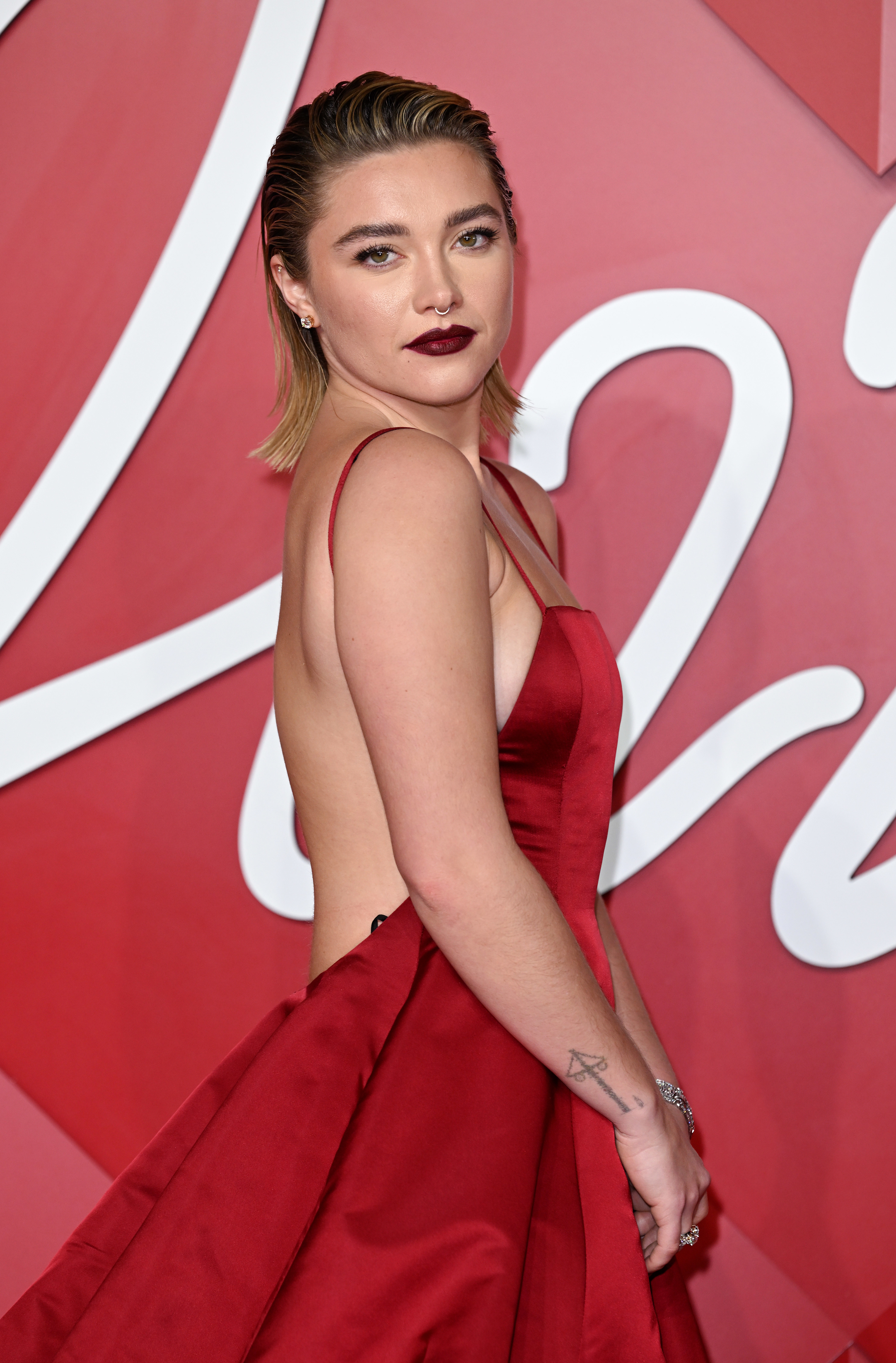 Close-up of Florence at a media event in a backless gown