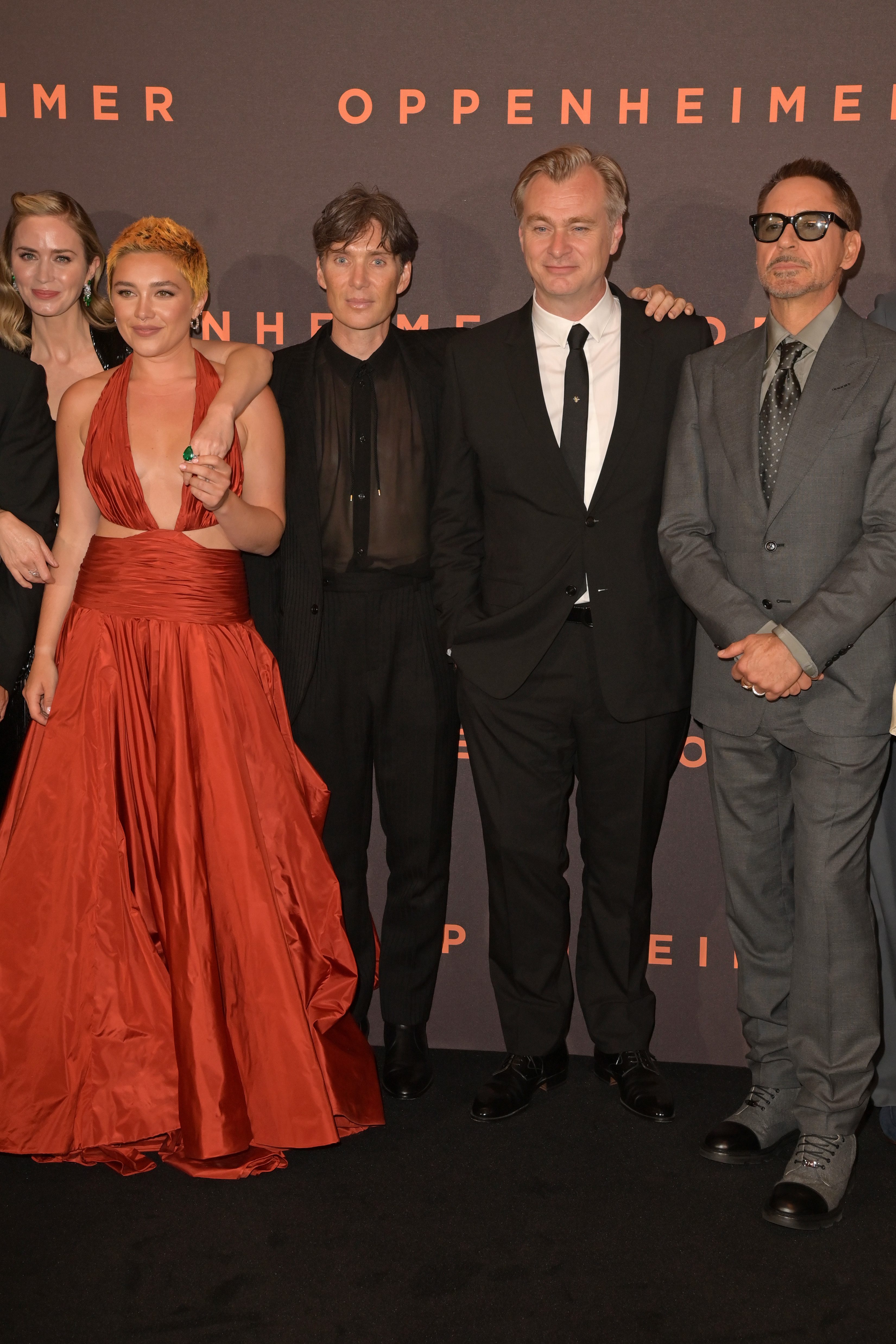 Close-up of cast members and Christopher at a media event