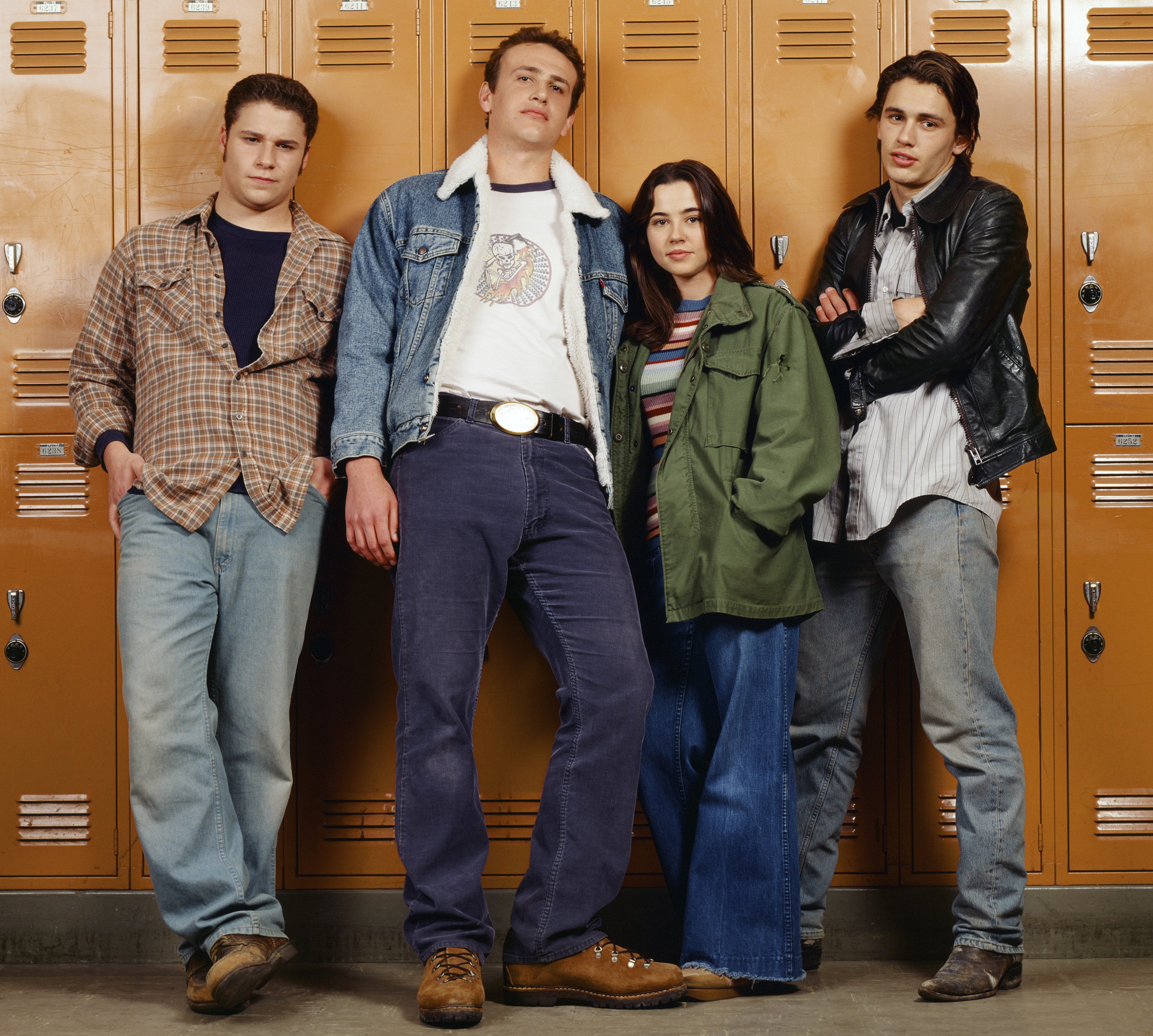 Teenagers in jeans slouched against school lockers