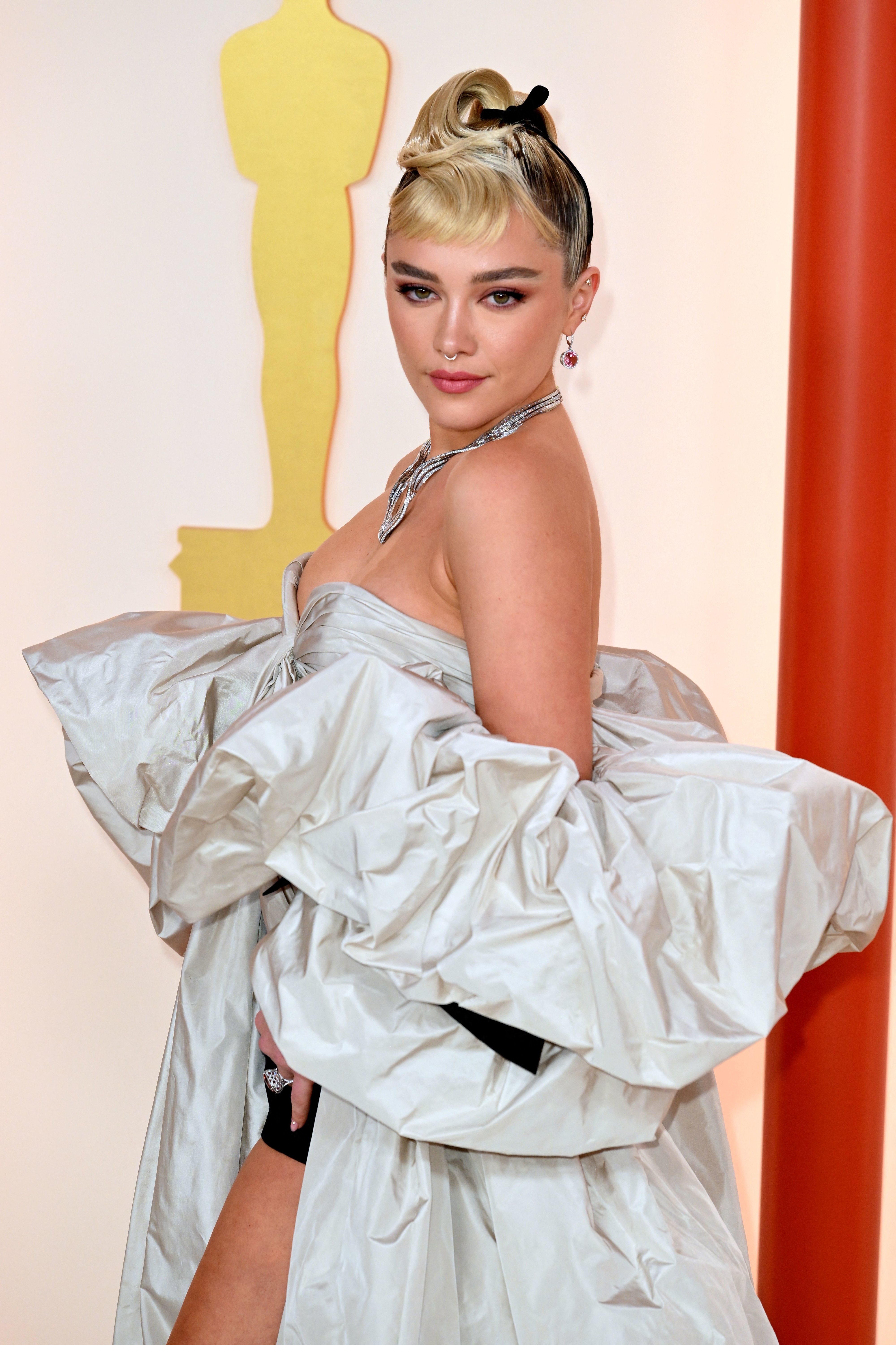 Close-up of Florence at a media event in a strapless outfit