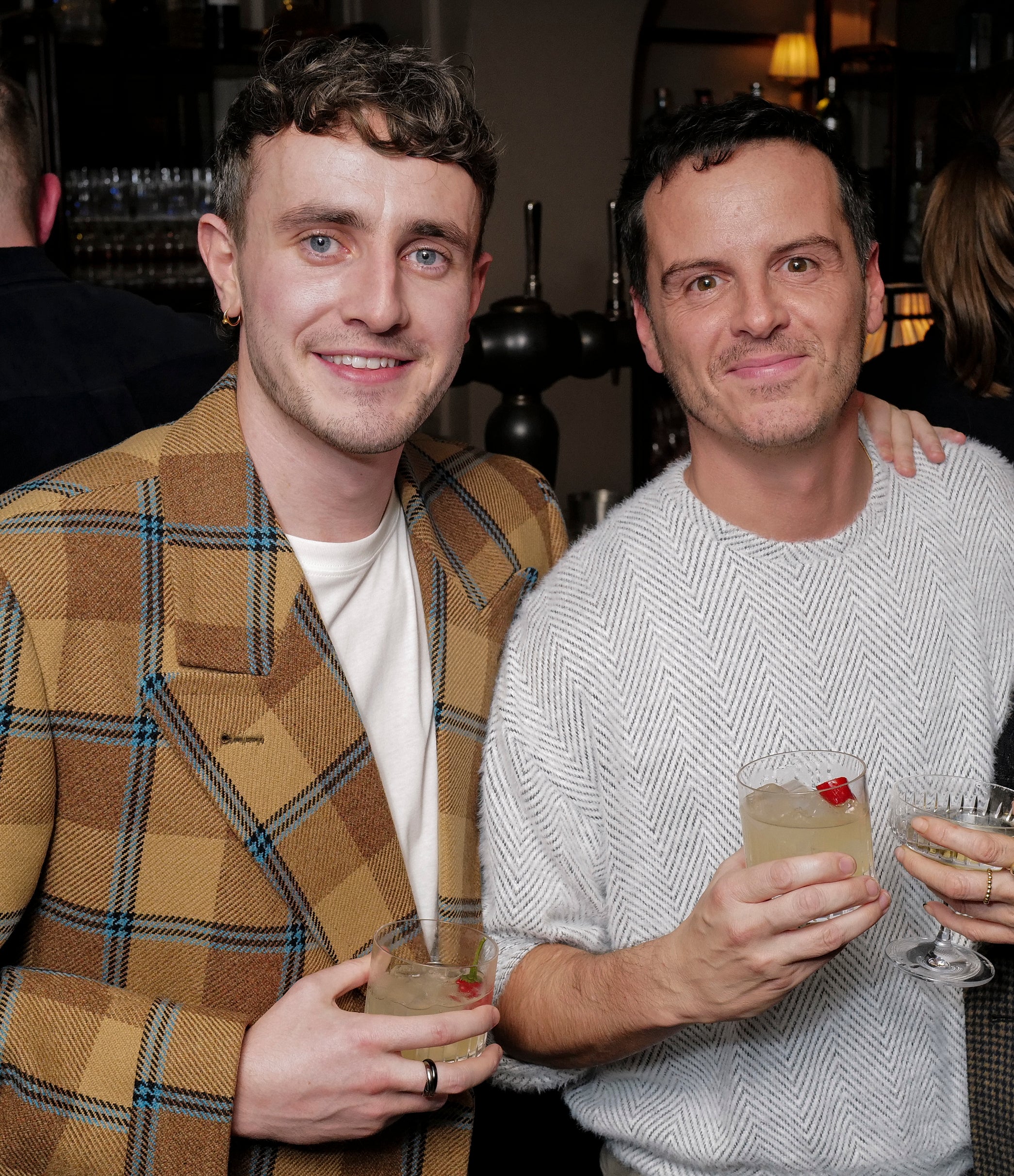 Close-up of Paul and Andrew holding drinks