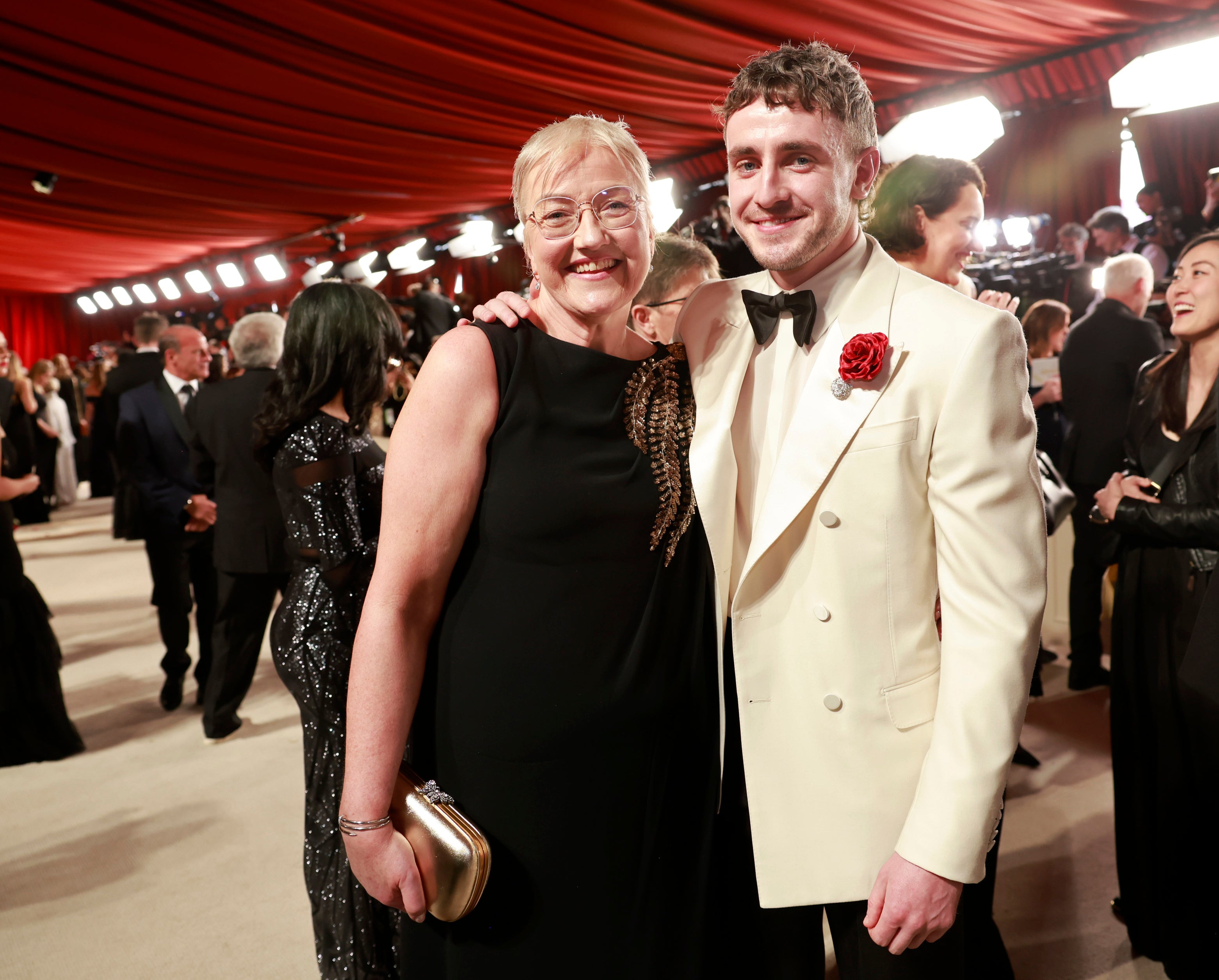 Paul and his mother smiling on the red carpet