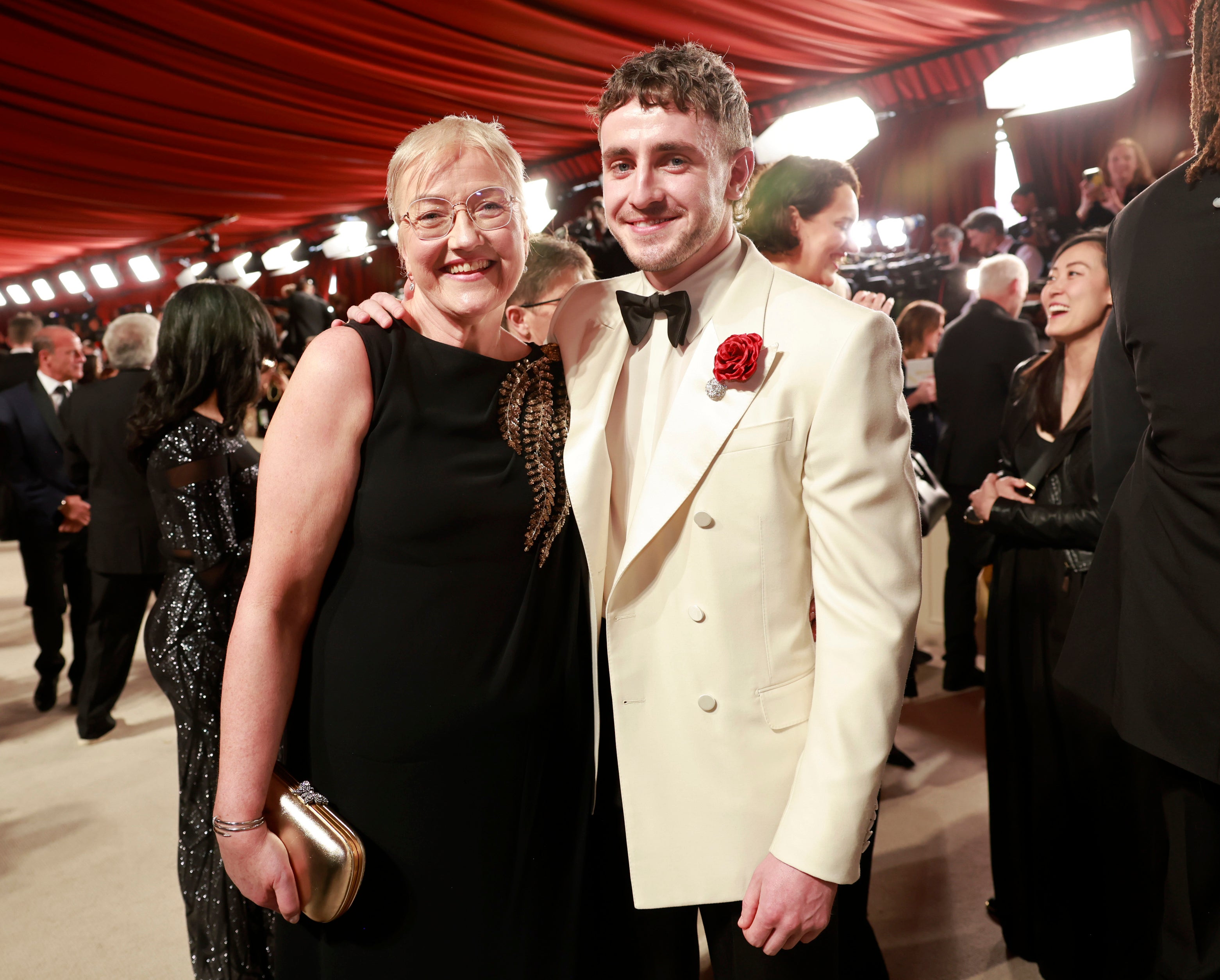 Paul and his mother smiling on the red carpet