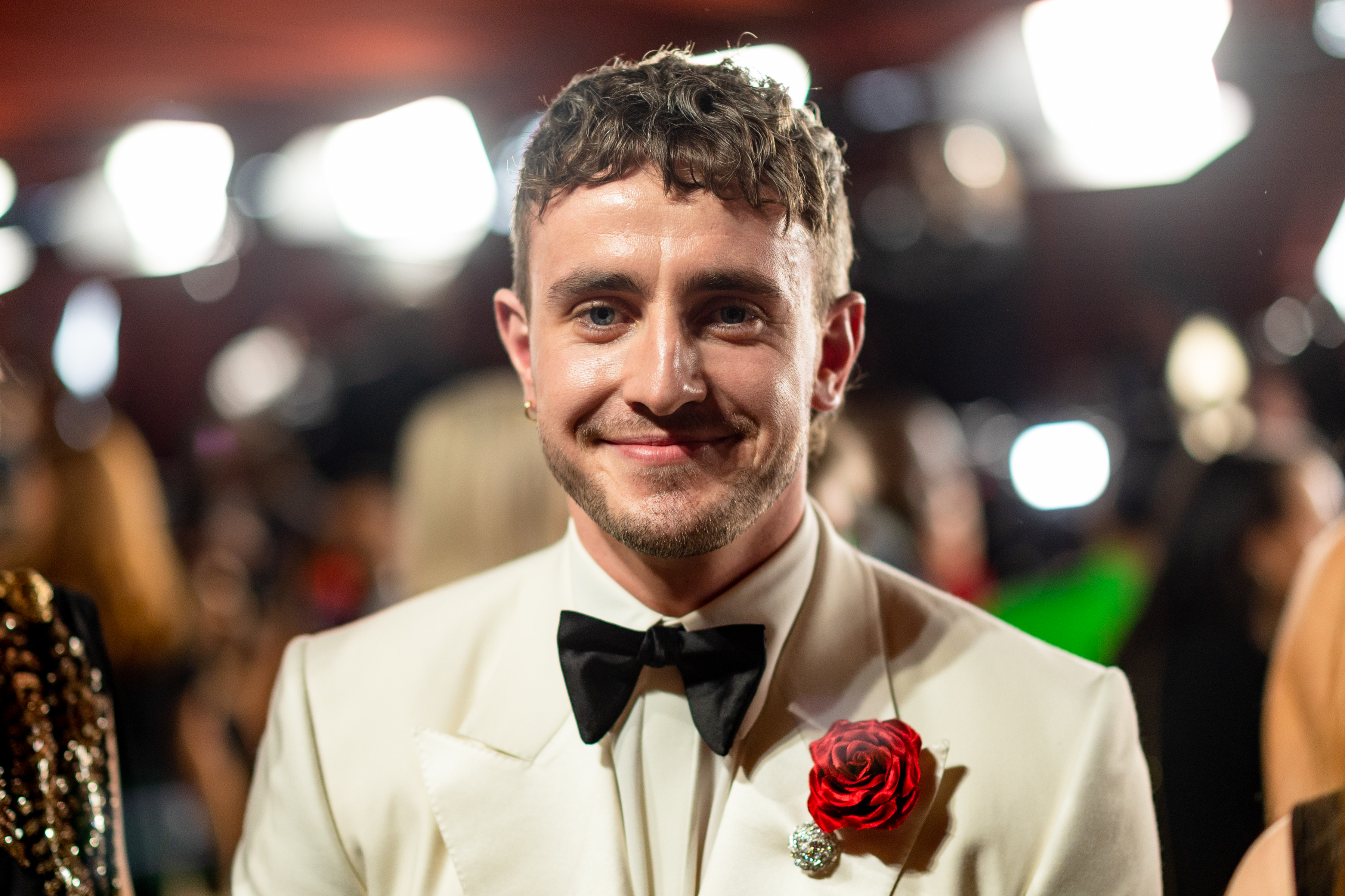 Close-up of Paul smiling and wearing a bow tie and corsage