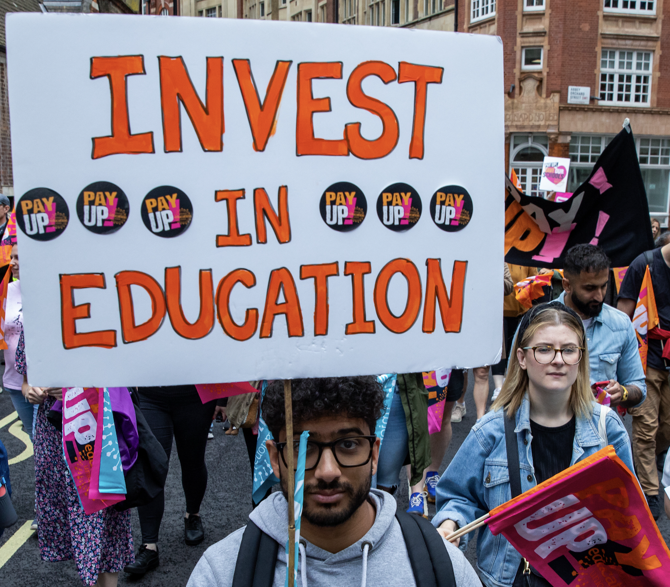 &quot;Invest in education &quot; sign held by protestor