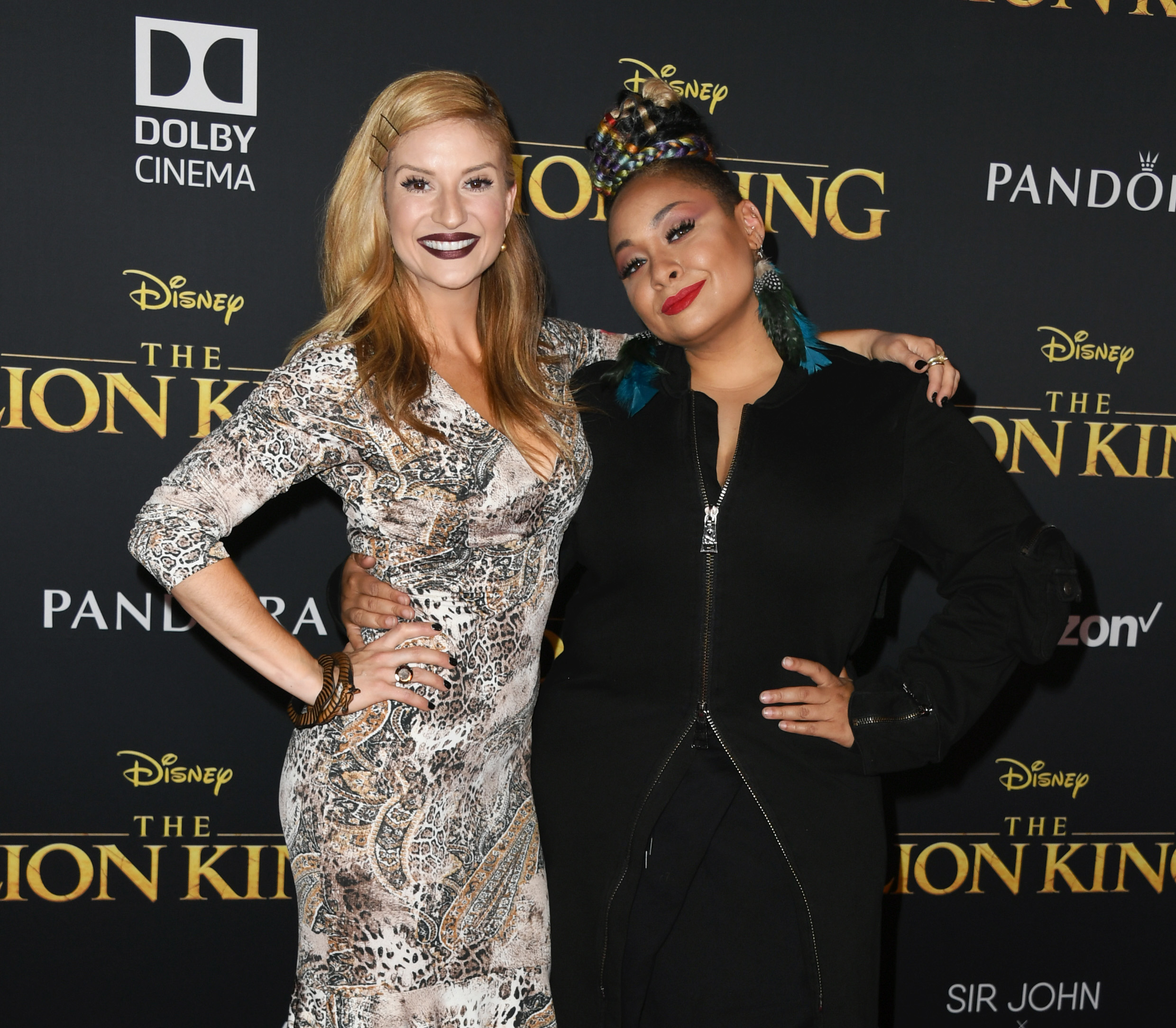 Anneliese and Raven smiling and hugging at a media event