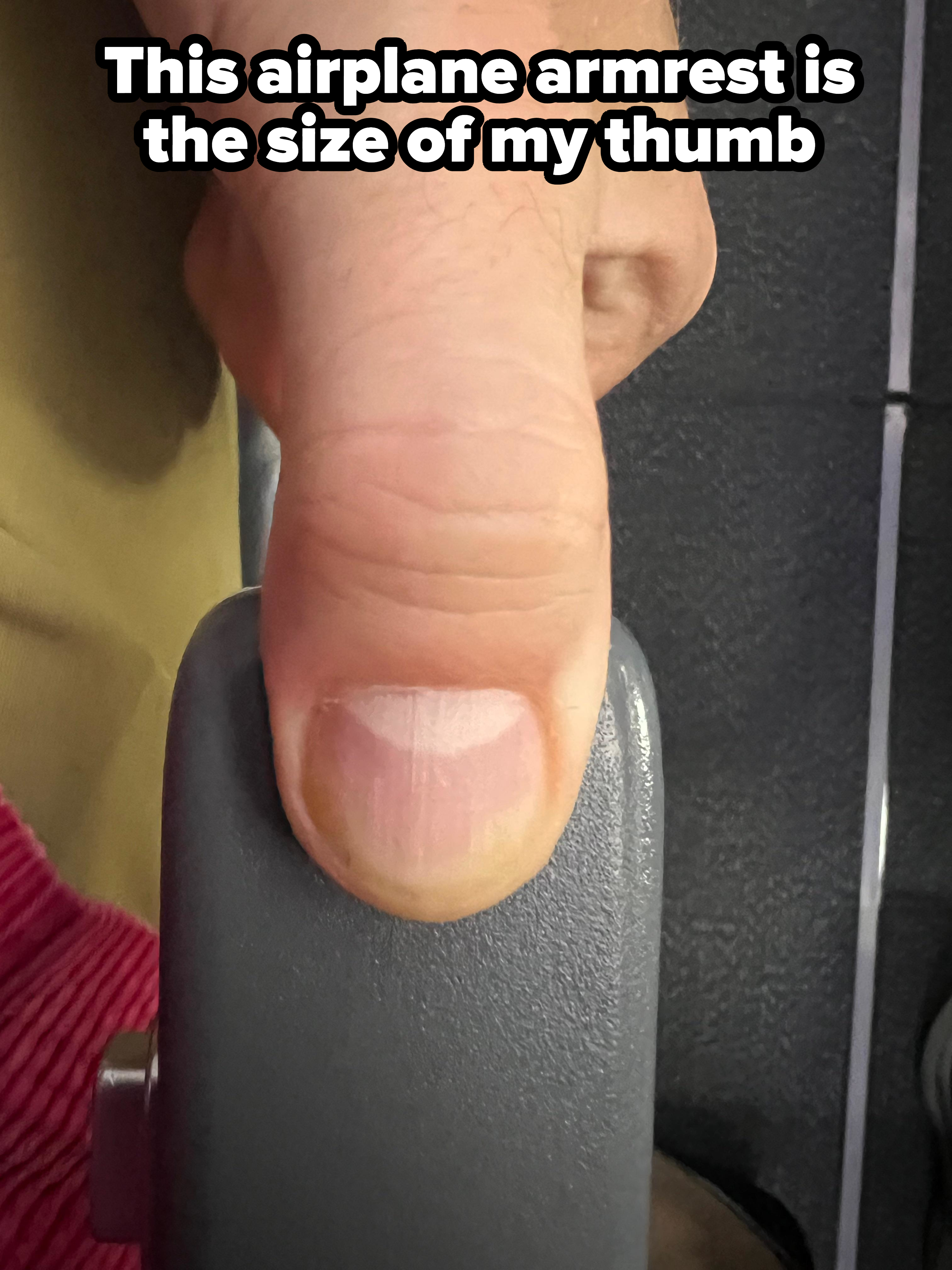 A thumb on an armrest