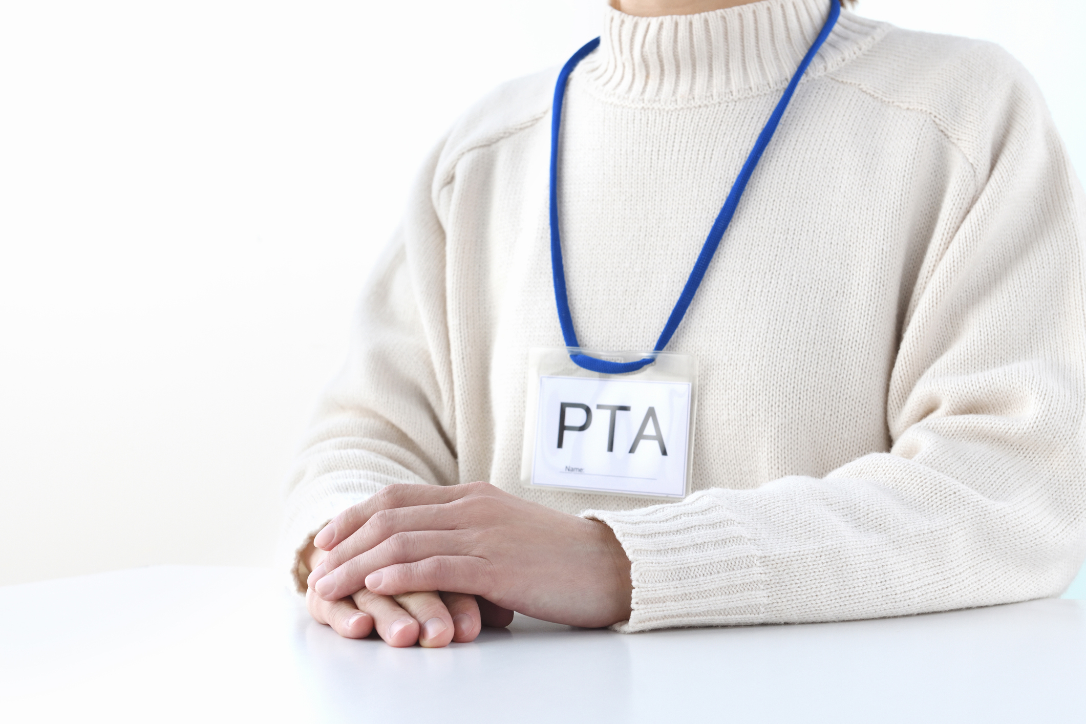 A person wearing a PTA card around their neck