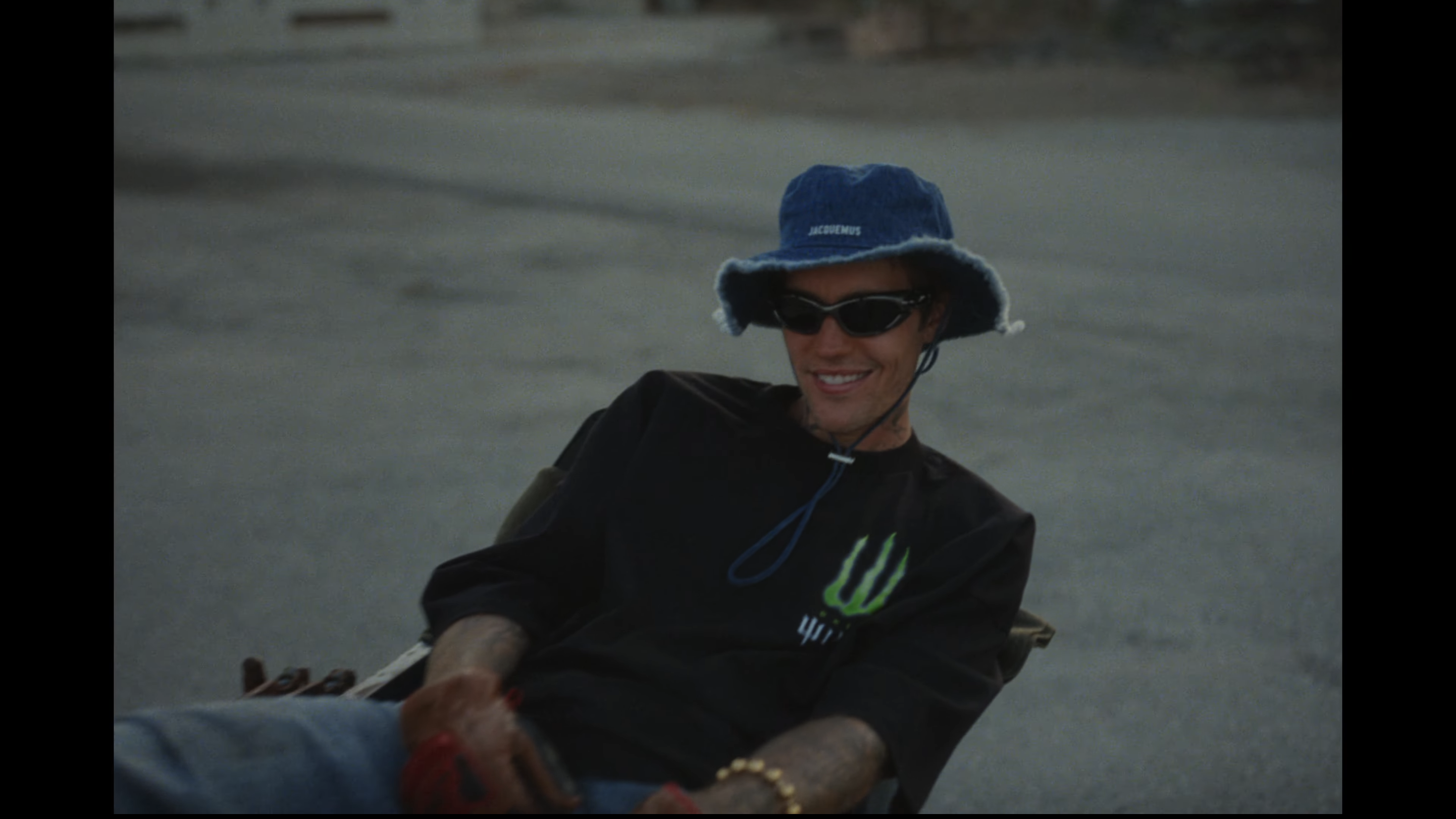Screenshot of Justin in the video smiling and leaning back in a chair