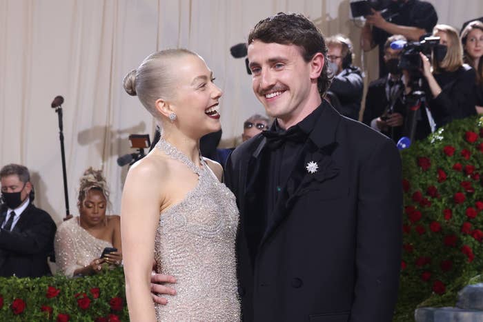 Phoebe Bridgers smiling at Paul Mescal as they stand on the red carpet