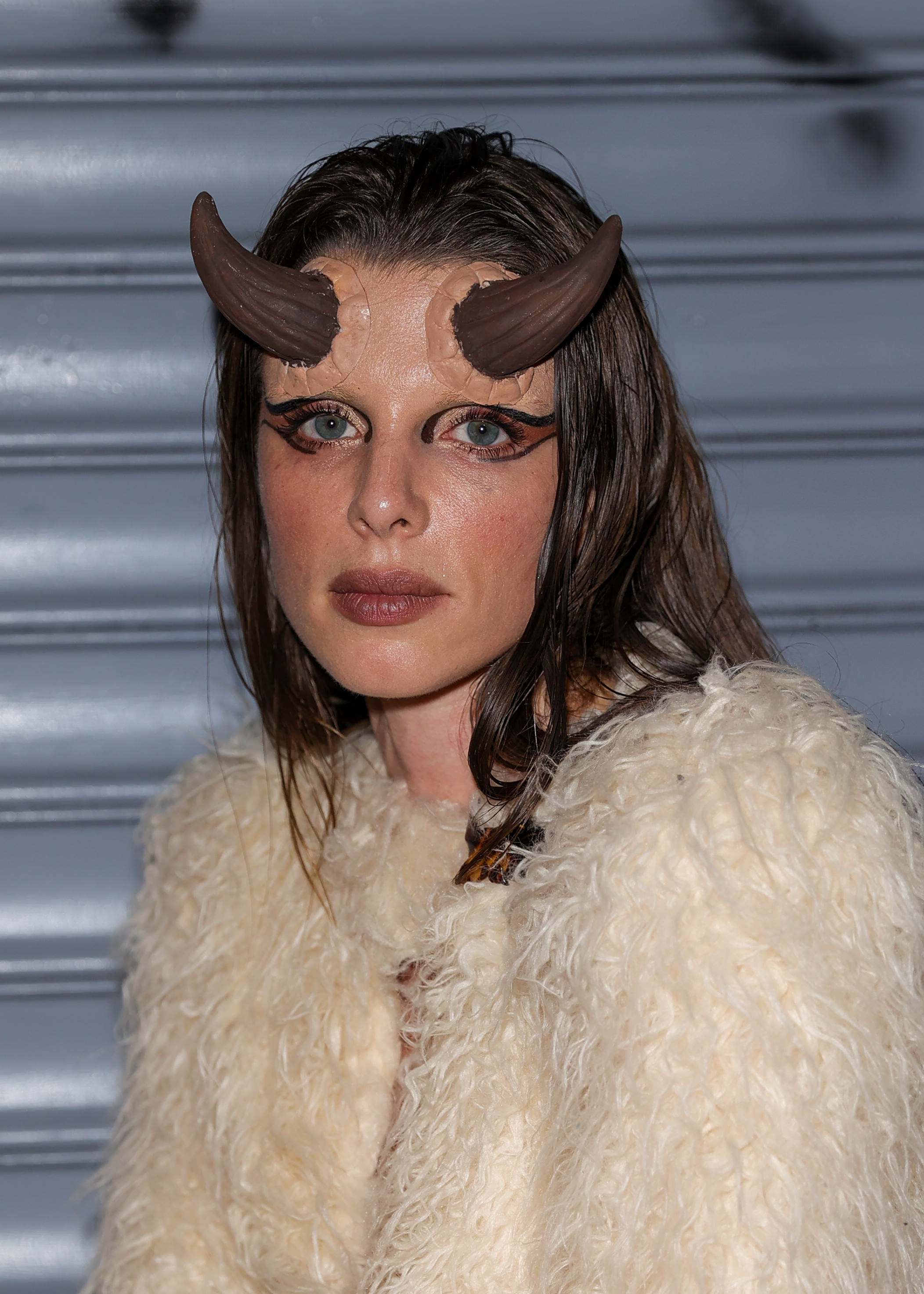 closeup of her with horns on her forehead