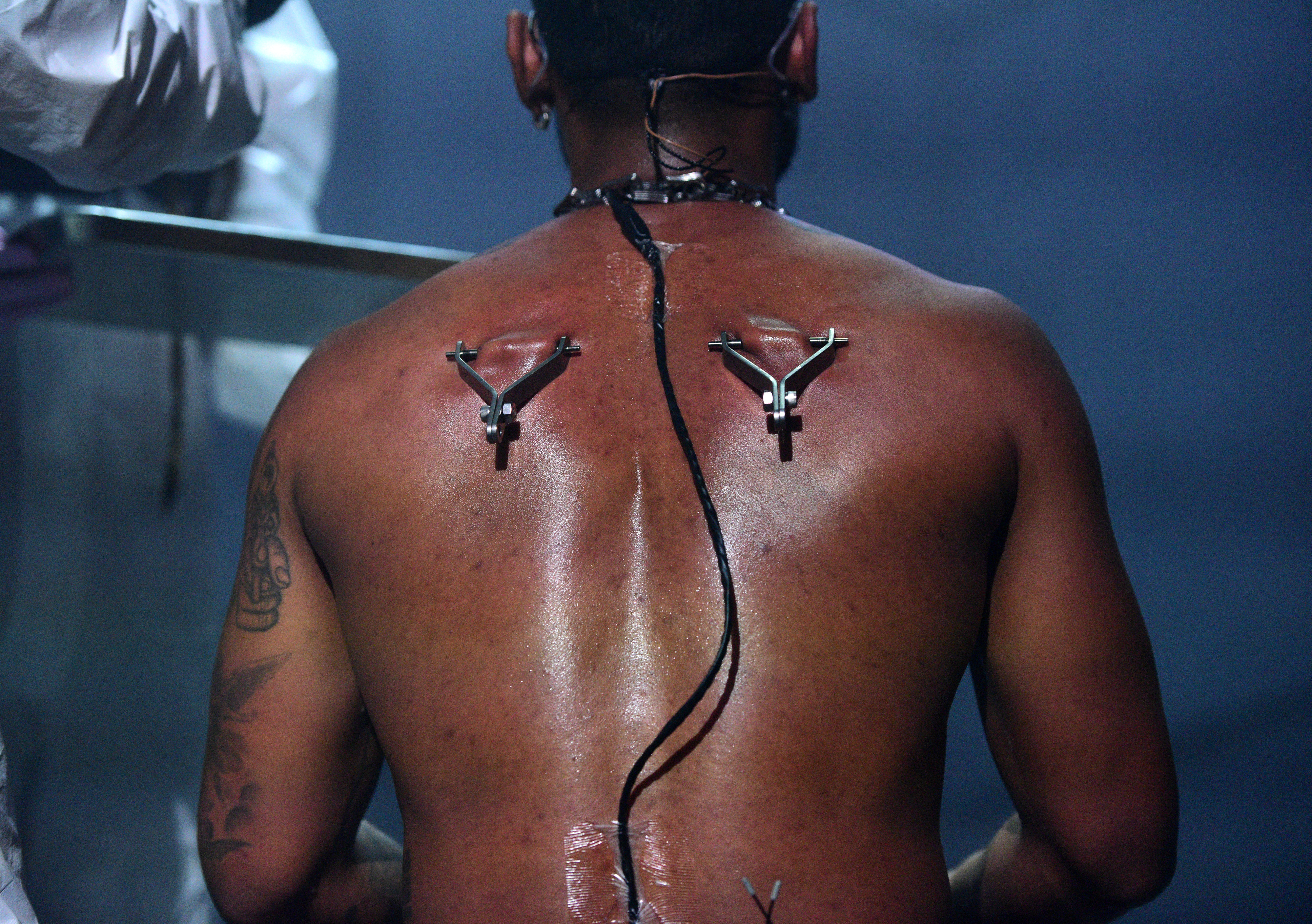 Miguel Performs Gruesome Body Suspension Show With Hooks In His Back