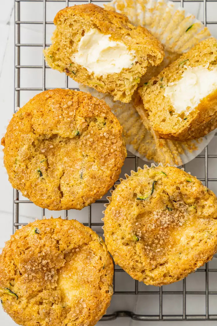 zucchini cream cheese muffins on a cooling rack