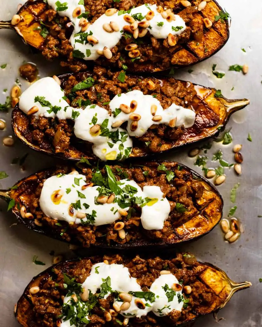 eggplants on a baking tray stuffed with meat