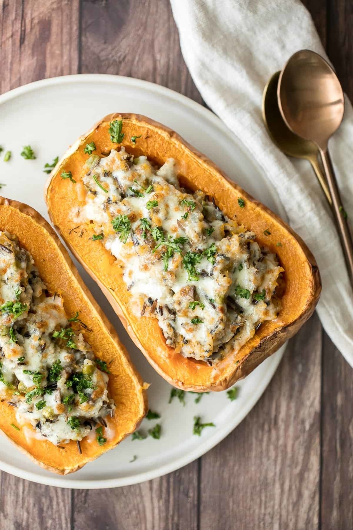 a butternut squash cut in half and stuffed with rice and cheese