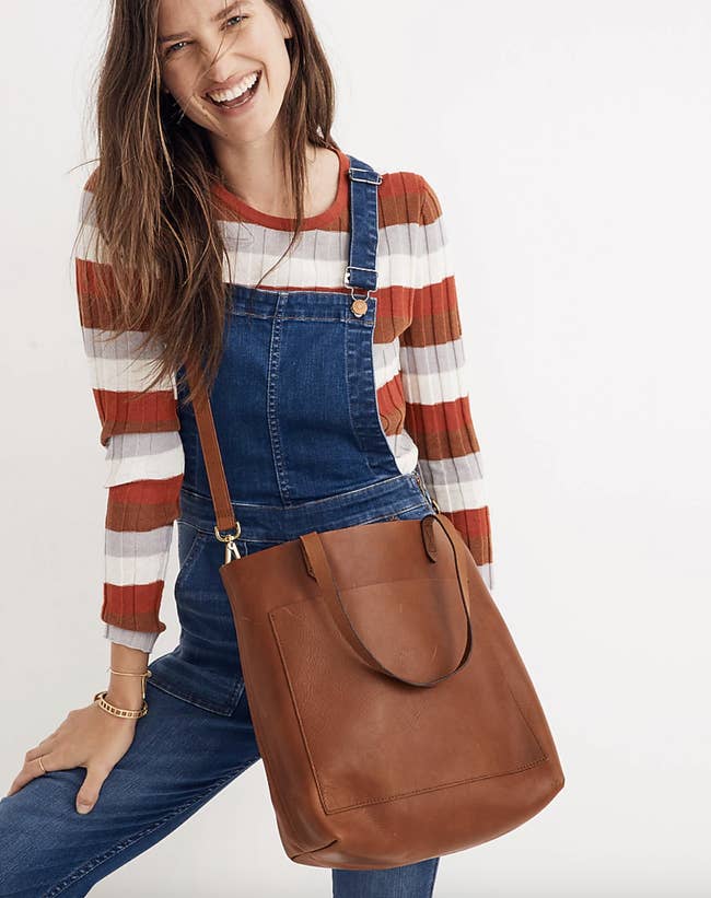 model carrying the brown leather tote