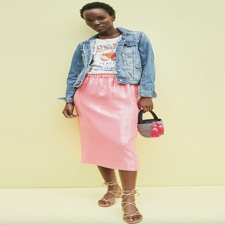 model wearing the denim jacket with a midi sequined dress