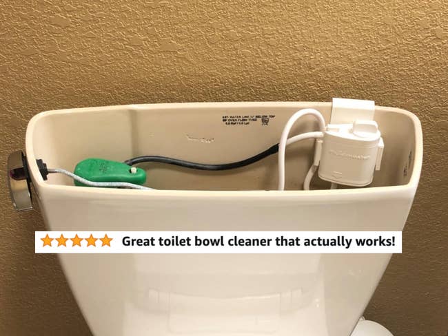 The system installed in a reviewer's toilet cistern with five star text 