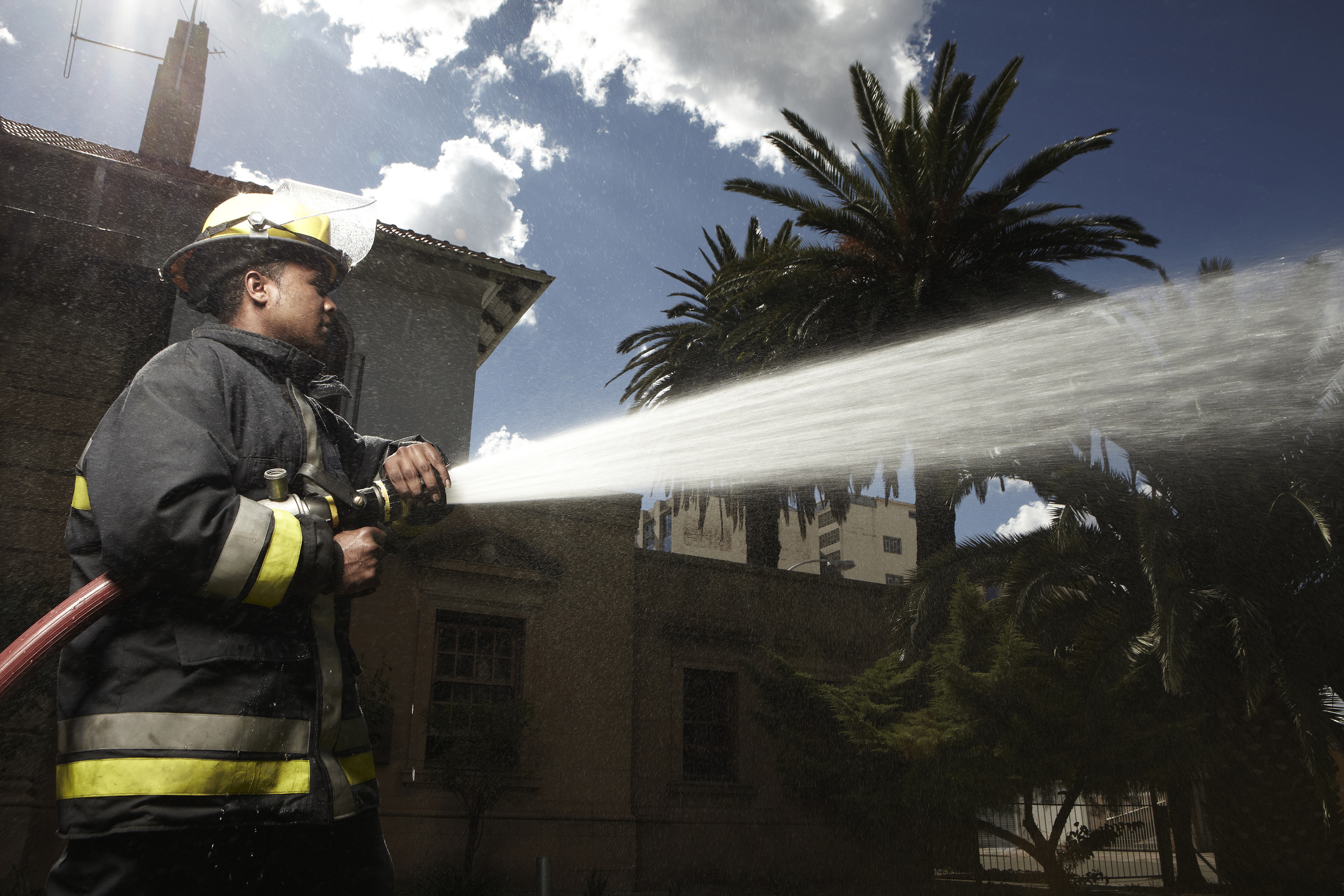 A firefighter using the hose