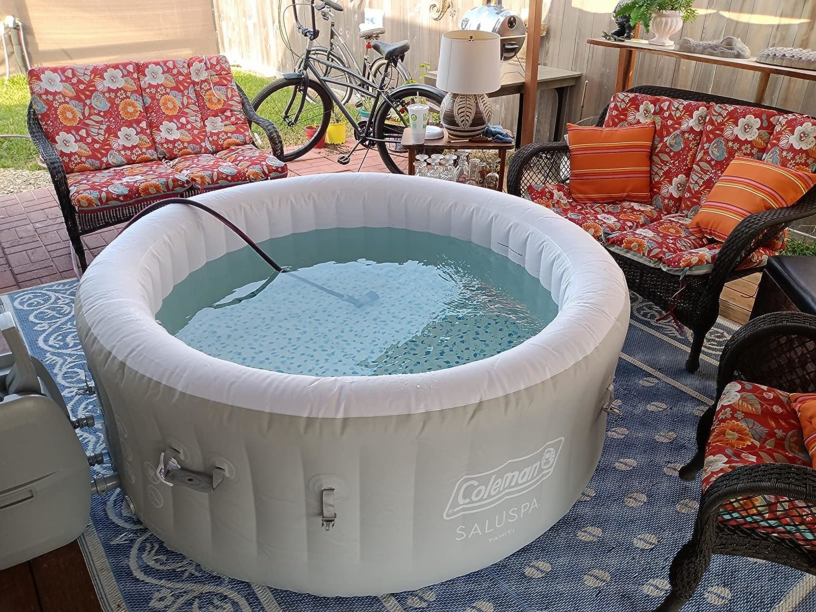 a reviewer photo of the hot tub being filled up with a hose