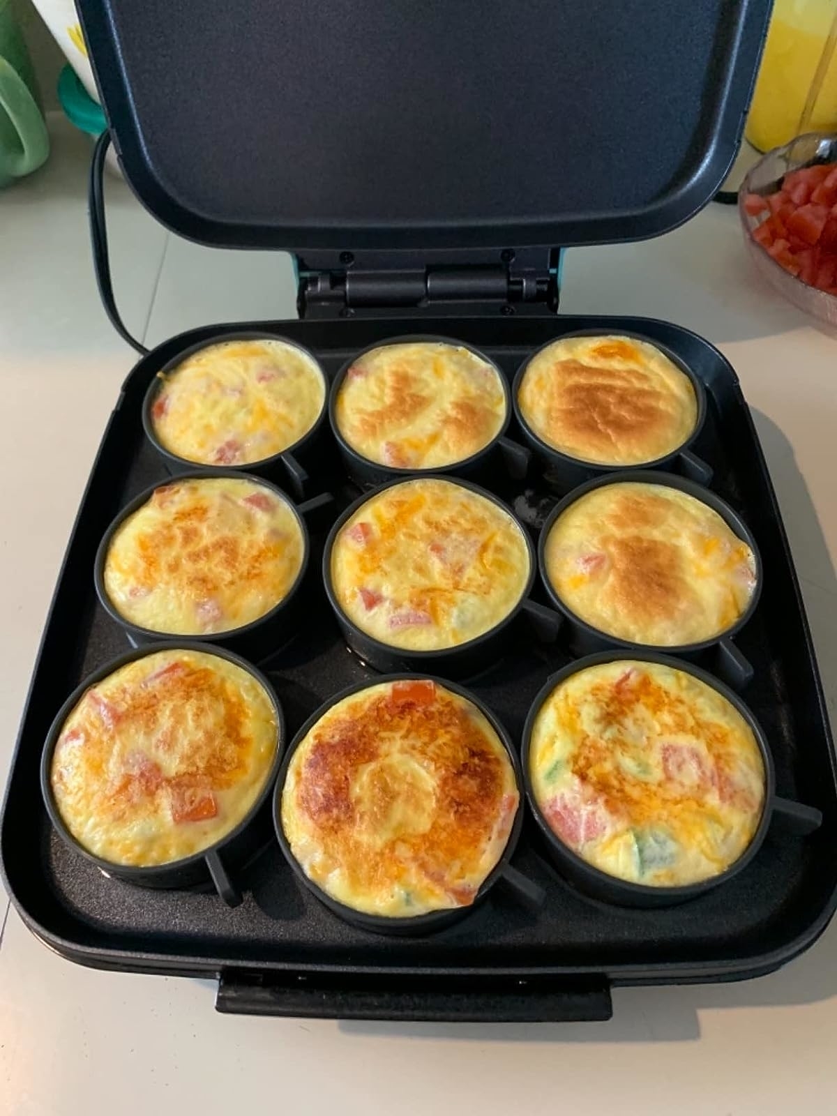 reviewer&#x27;s egg bite maker with cooked egg bites in them