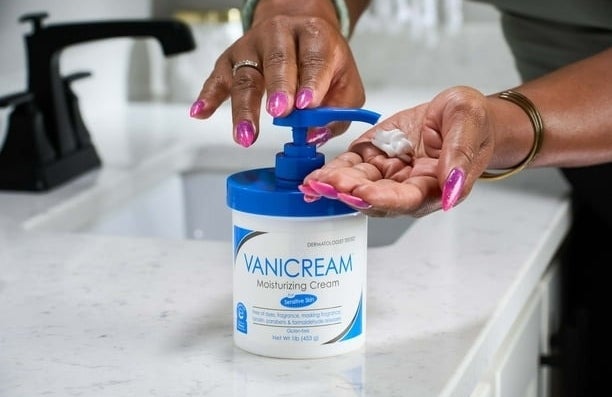 a model putting the hand cream on