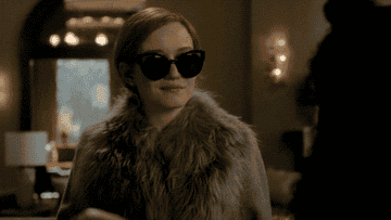 Julia Garner taking off her sunglasses as Anna Delvey in &quot;Inventing Anna&quot;