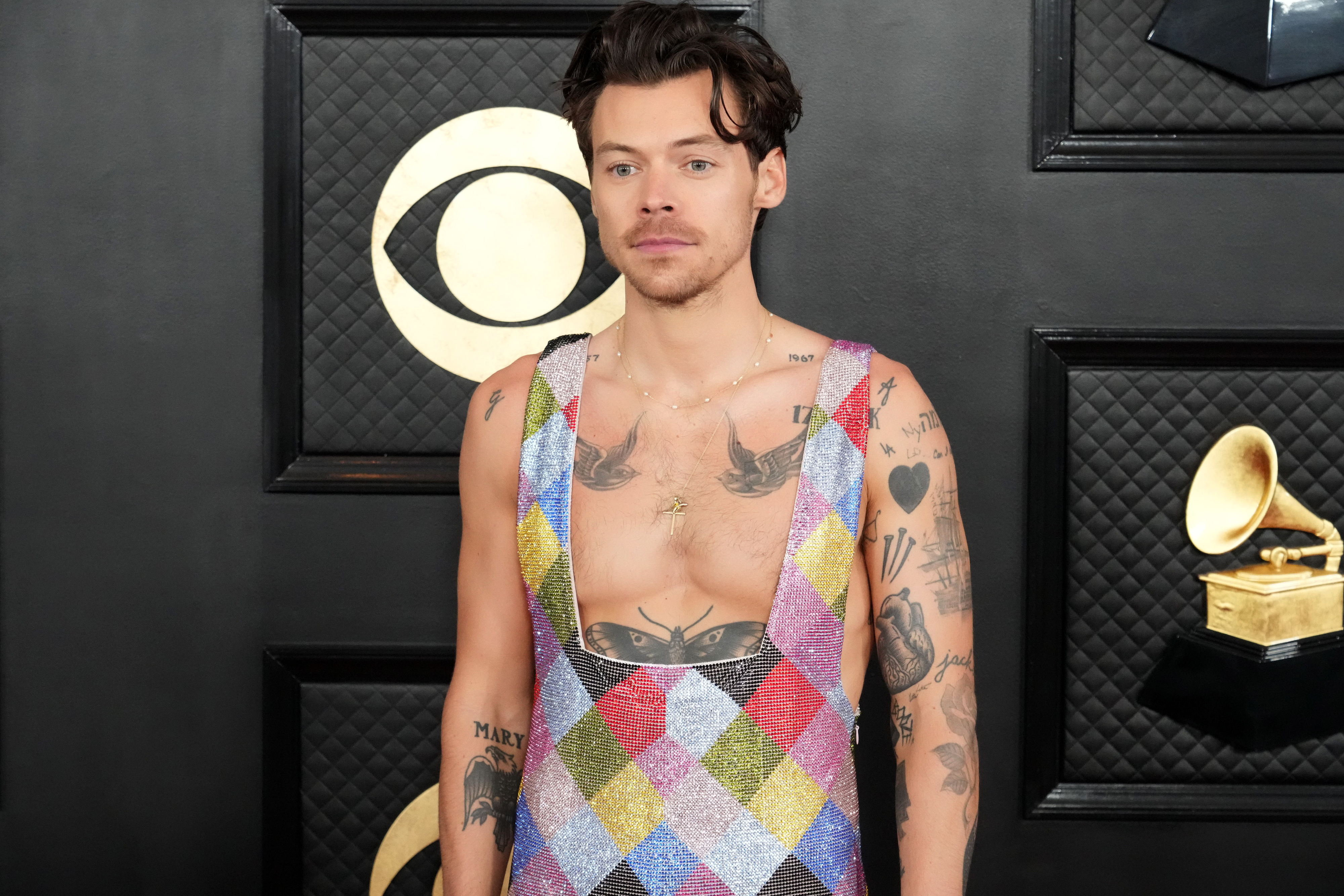 Harry Styles on the Grammys red carpet in a multicolored jumpsuit