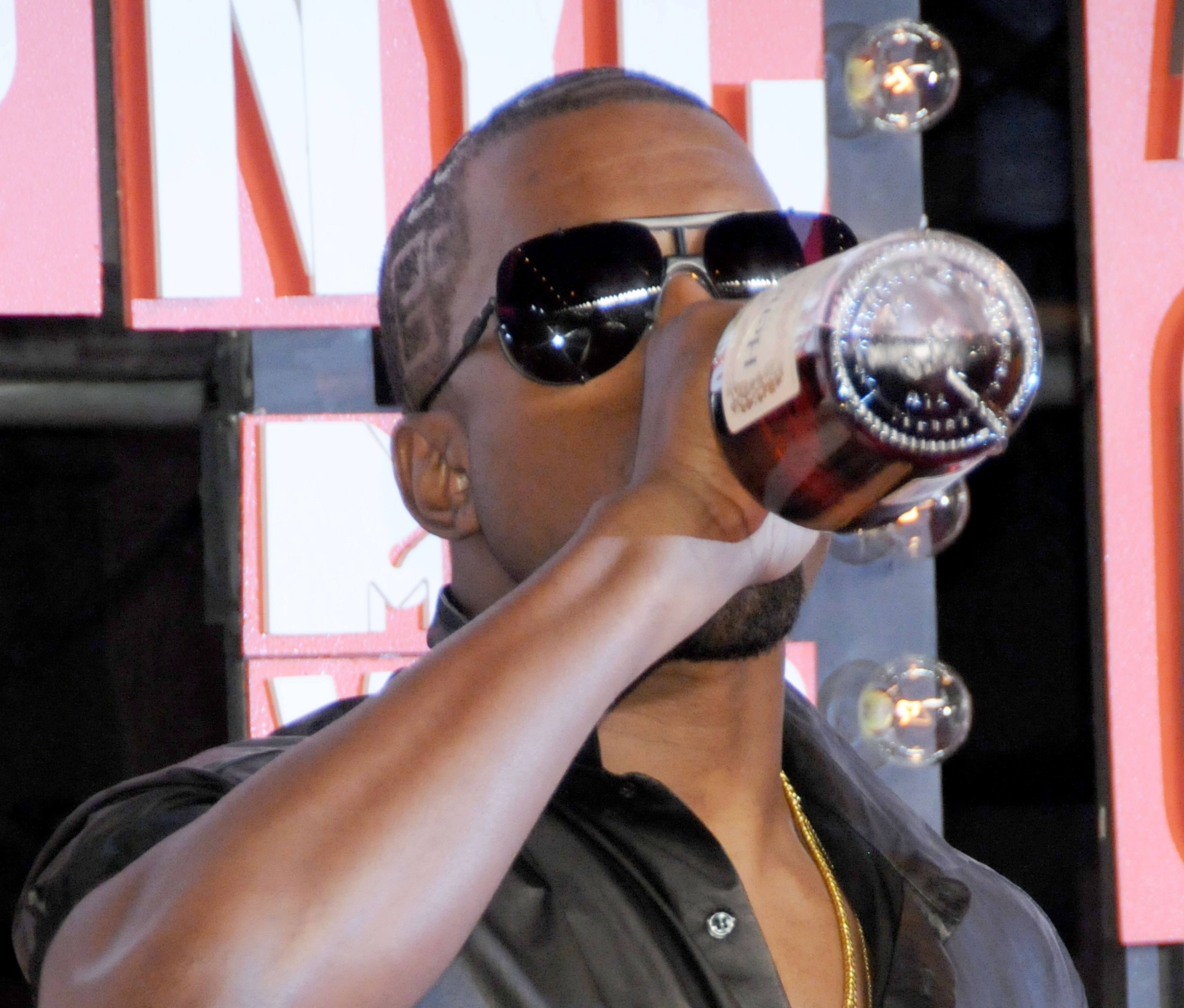 Kanye drinking straight from a bottle on the red carpet