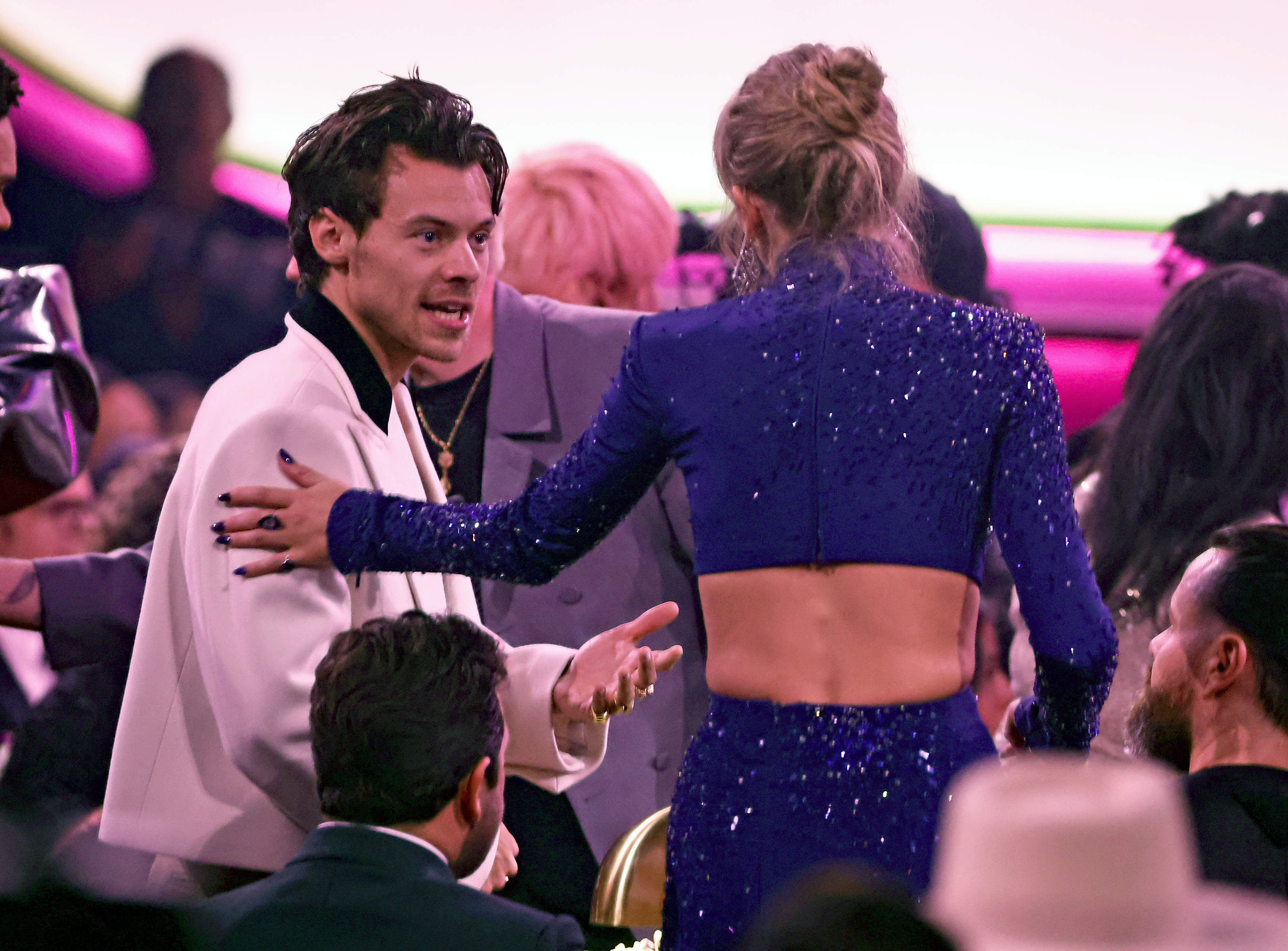 Closeup of Harry and Taylor talking in the crowd