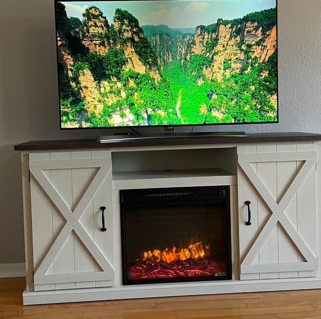 Reviewer&#x27;s photo of the fireplace TV stand.