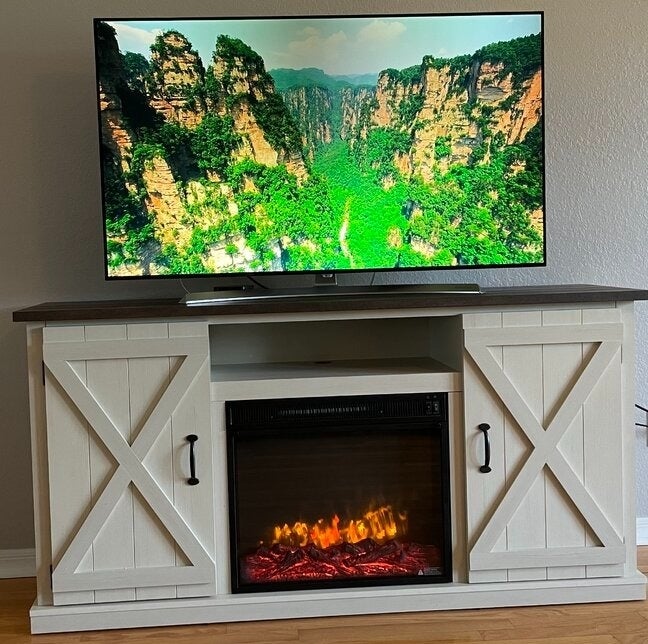 Reviewer&#x27;s photo of the fireplace TV stand.