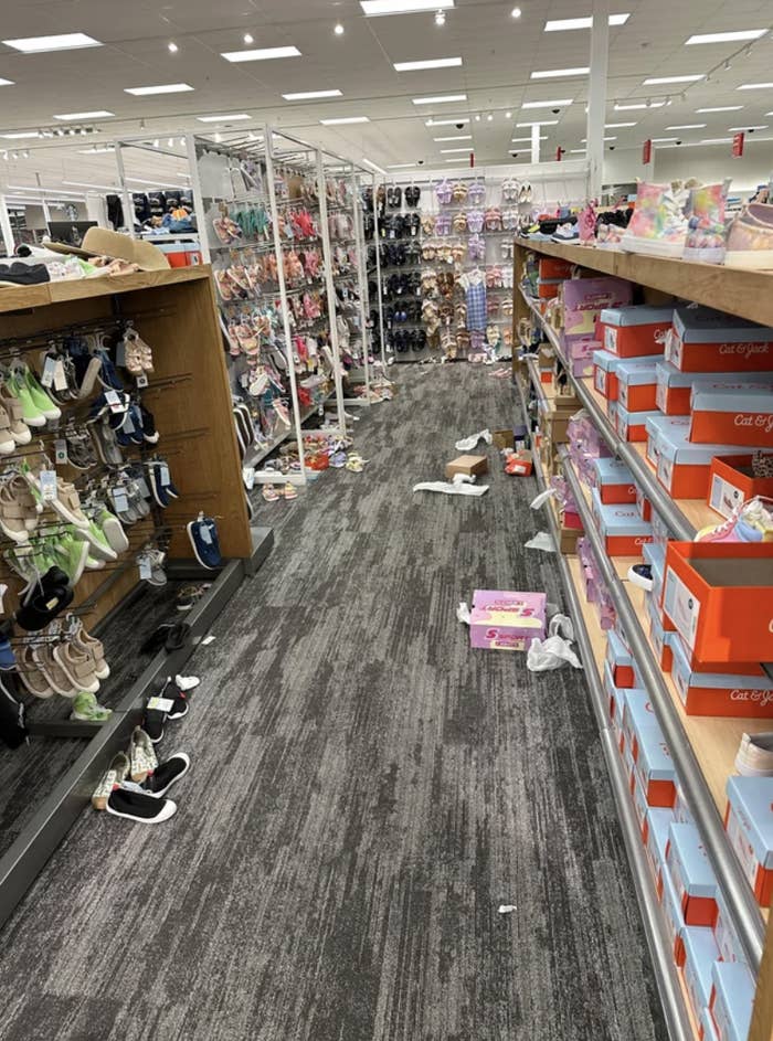 A messy shoe store aisle