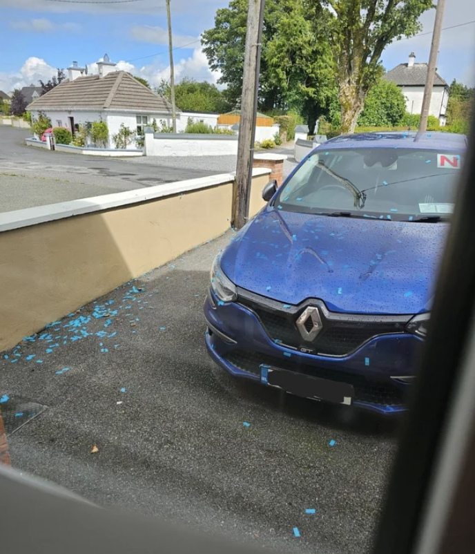 Blue confetti all over the parking lot and someone&#x27;s car
