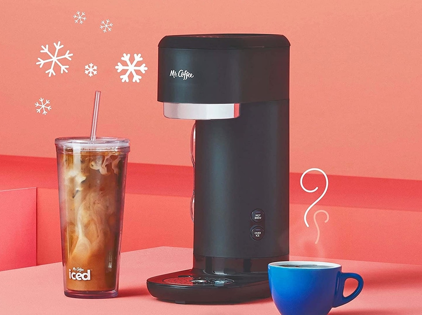 the coffee maker next to a cup of iced coffee and hot coffee