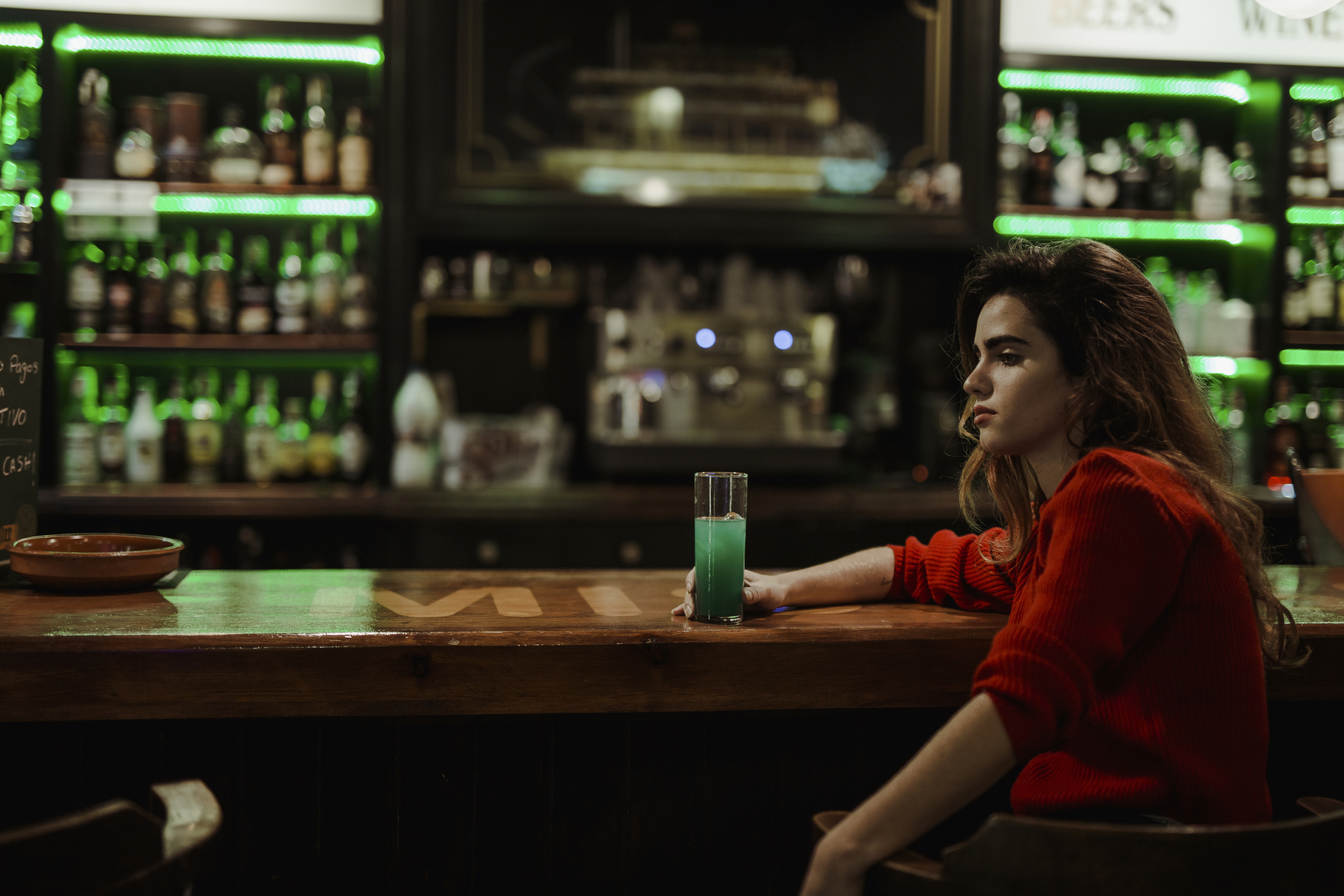a woman sitting at a bar alone